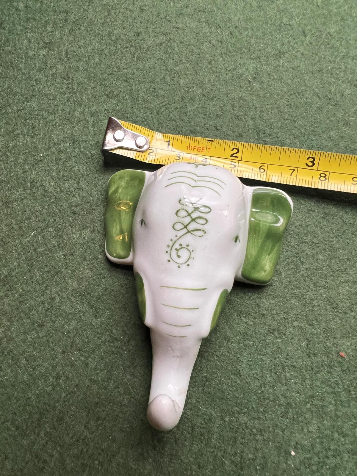 Vintage ceramic elephant head wall hanging. Hand painted green details.