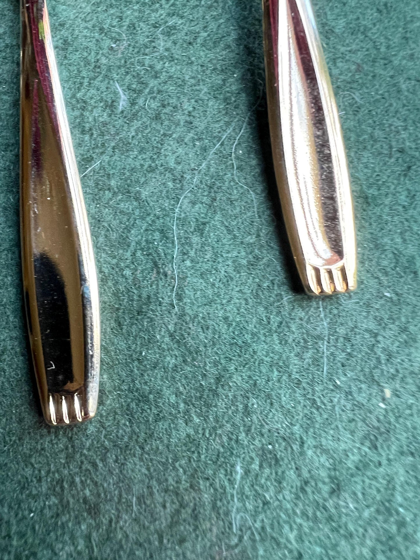 Set of seven Bronze plated sugar spoons with quirky handle end pattern.