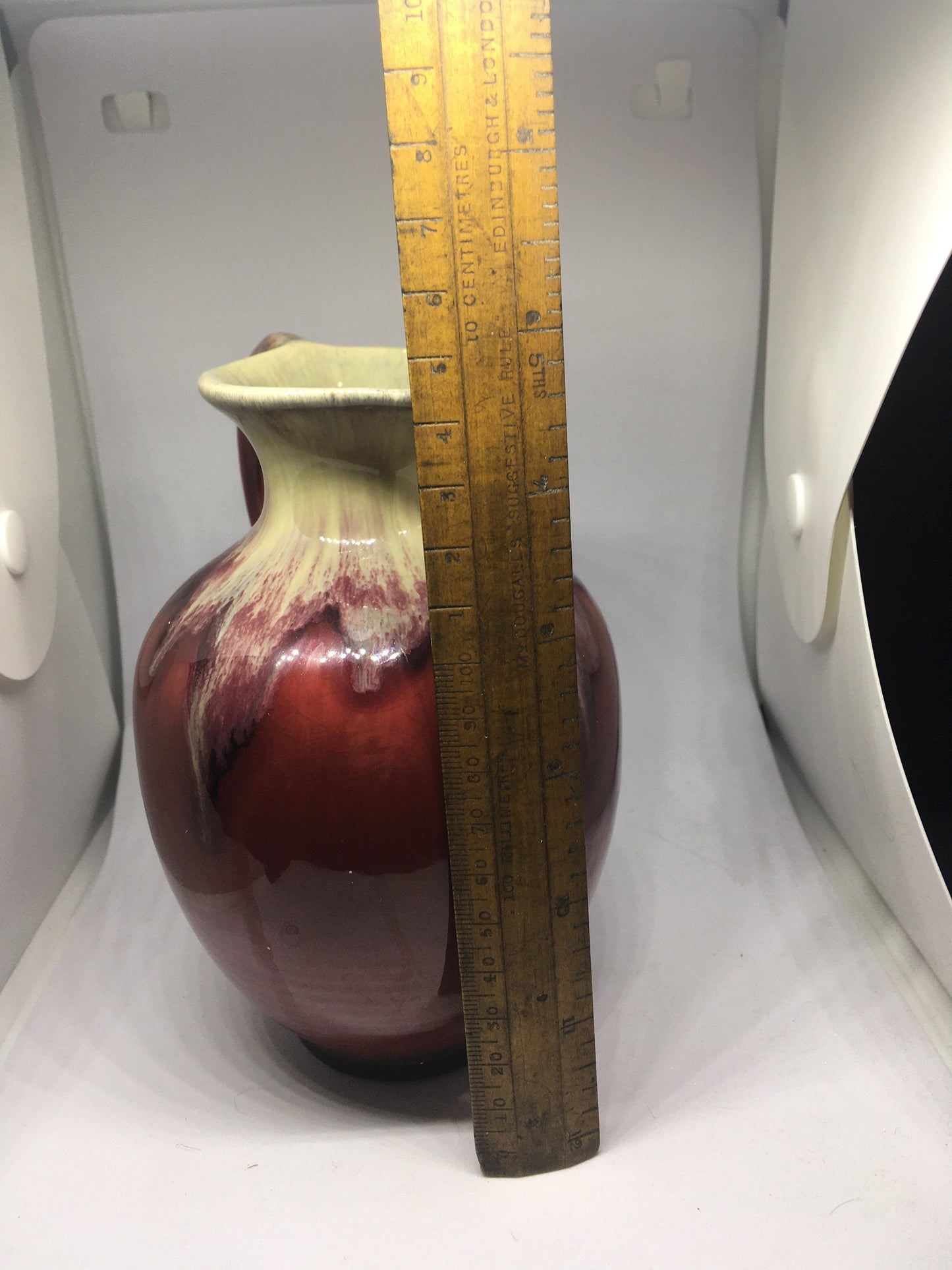 Water jug. German pottery pitcher. Beautiful red and cream drip glazed. Marked Germany.
