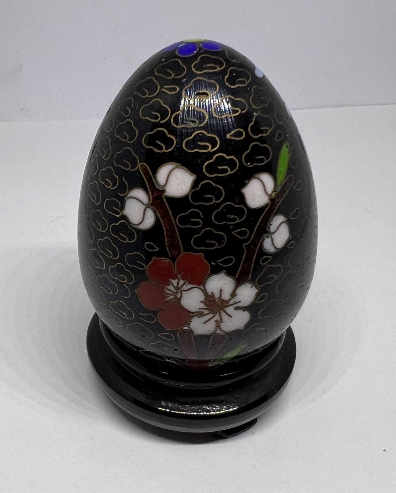 Vintage cloisonne egg with stand. Stunning floral design on black enamel background.