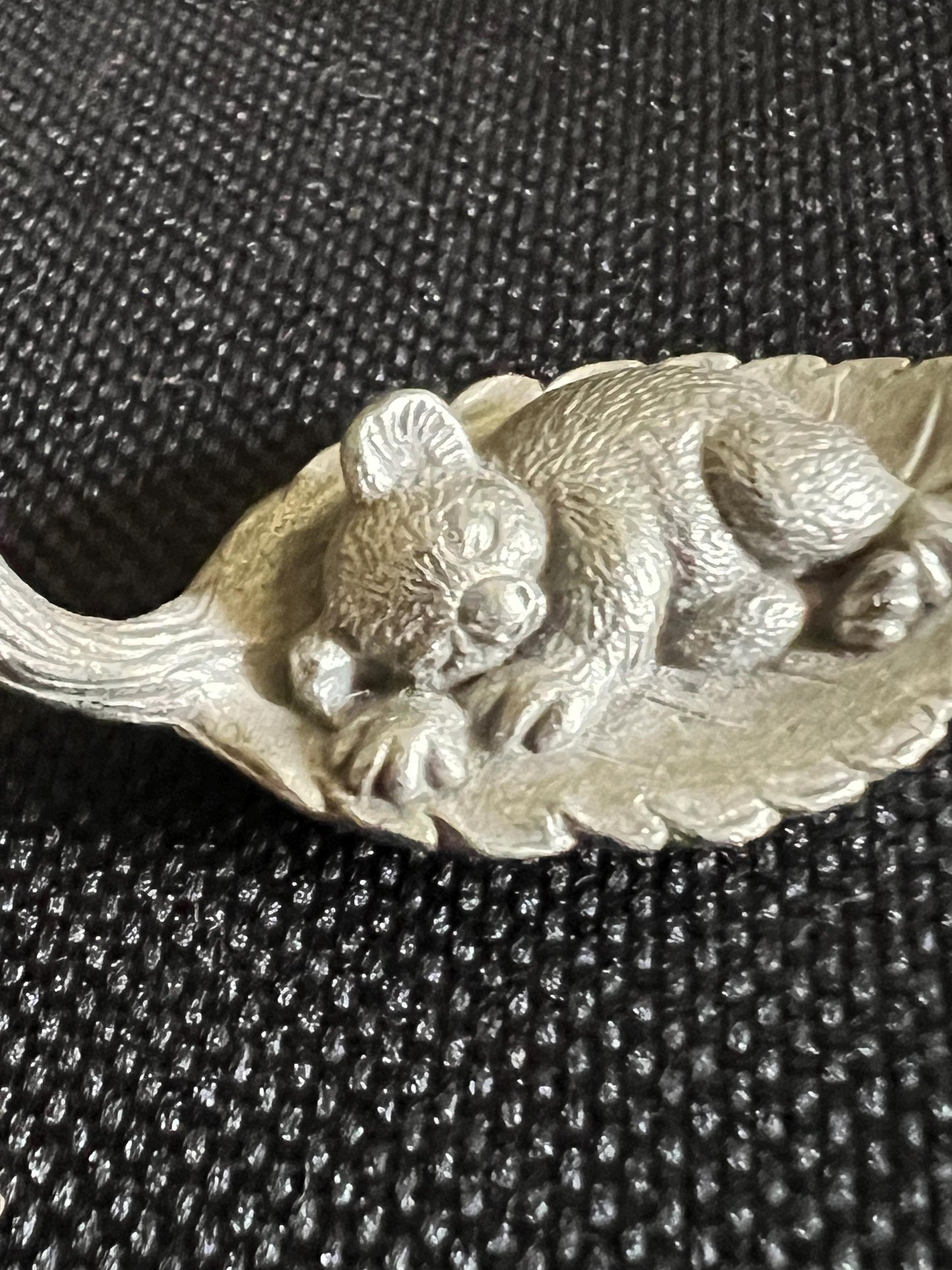Tiny koala sleeping on a leaf. Pewter miniature figurine.
