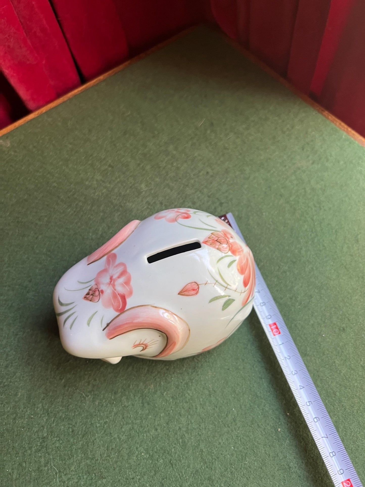 Ceramic elephant money box. Hand painted pink floral design. Made in Thailand.