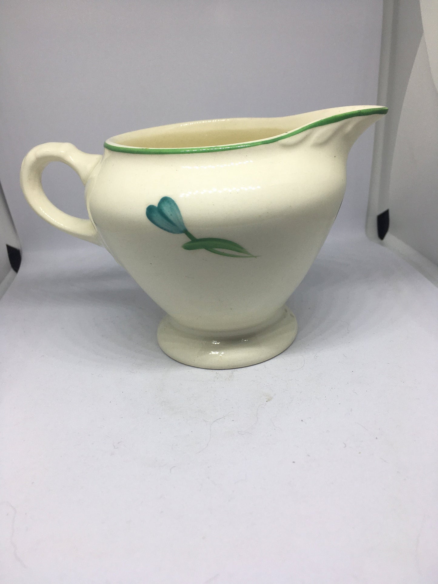 Ceramic hand painted milk jug. Stamped Ainsley England.