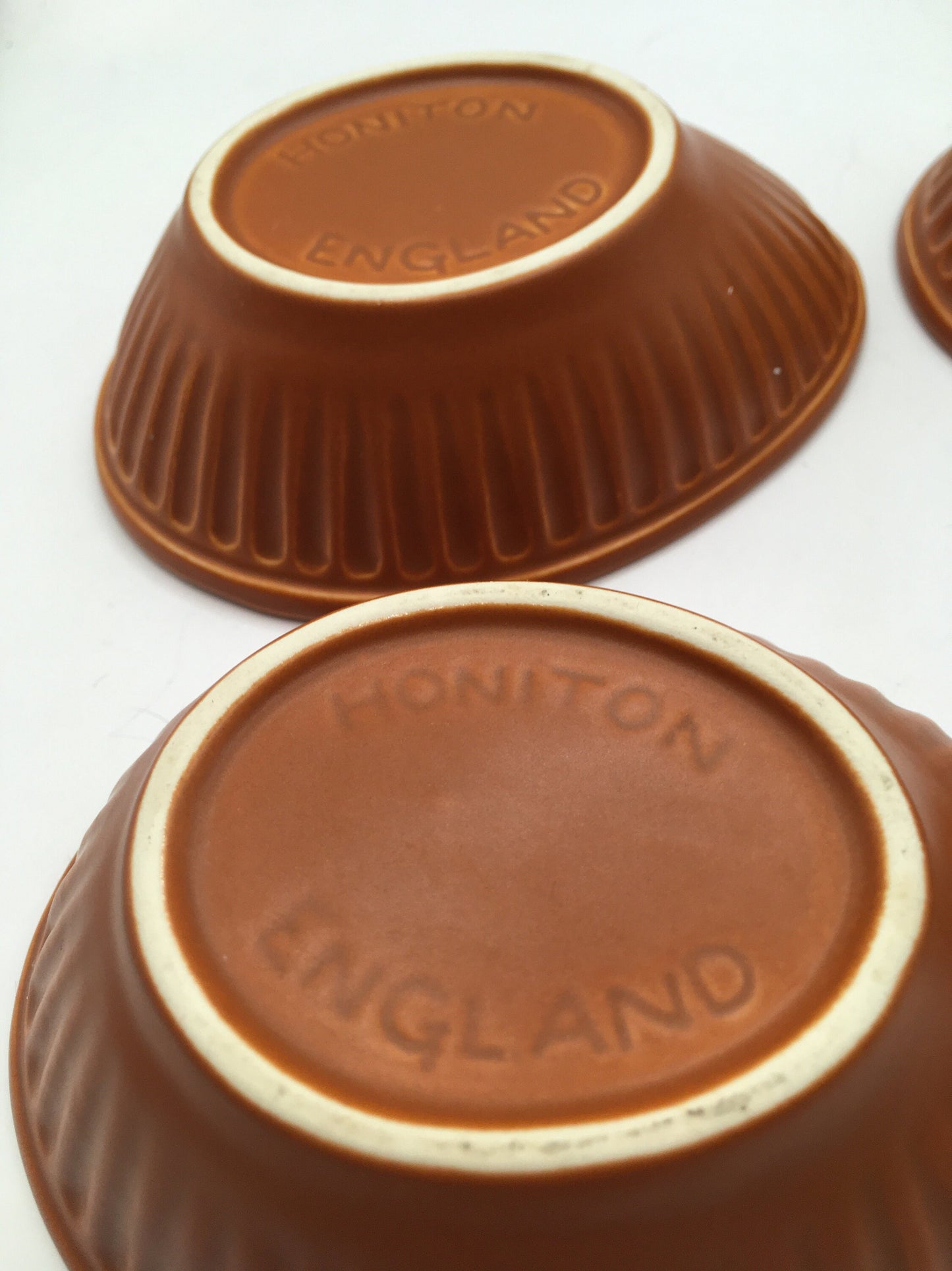 Honiton Pottery Avocado dishes. Set of 4 orange glazed stripe edged set.