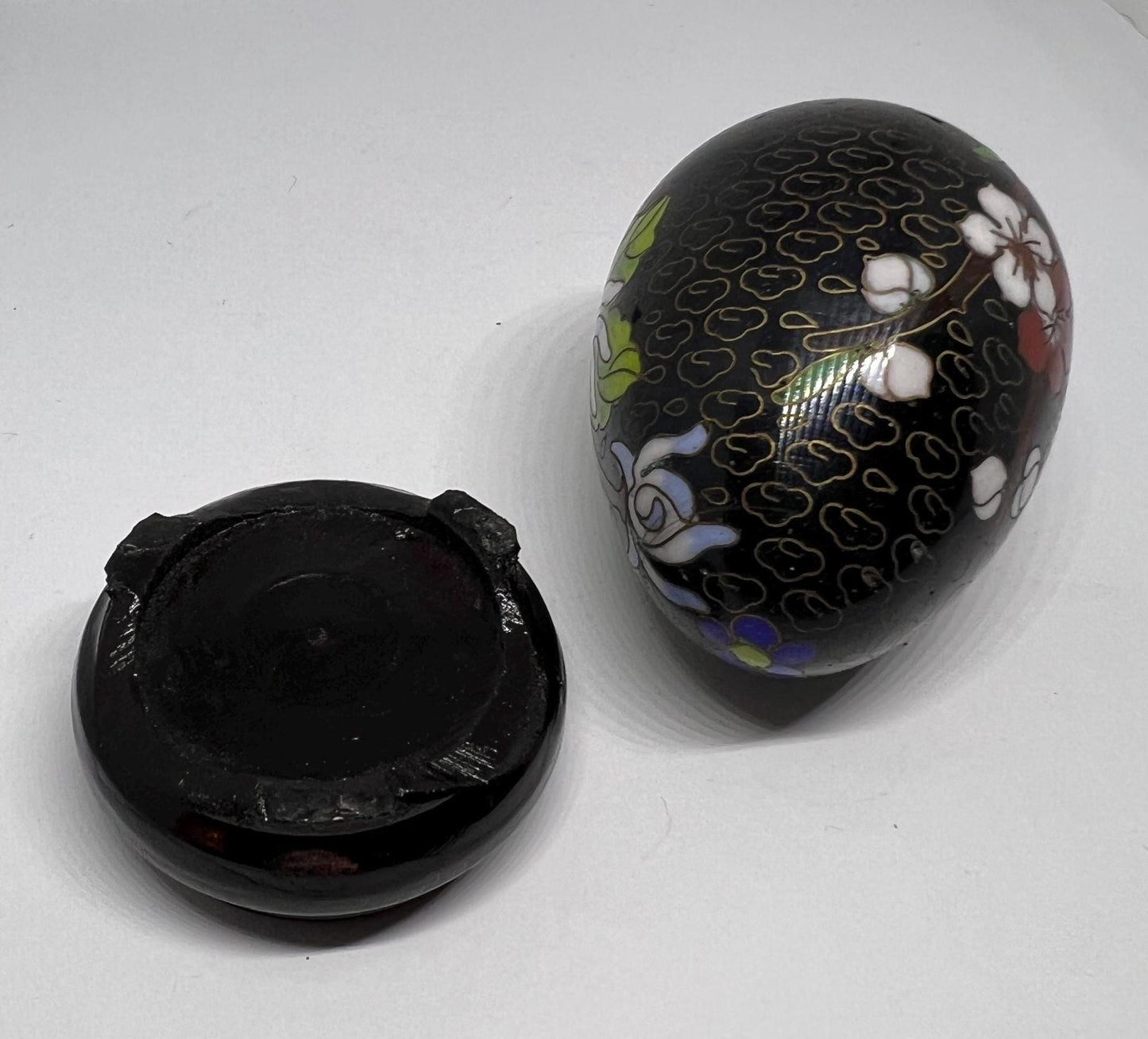 Vintage cloisonne egg with stand. Stunning floral design on black enamel background.