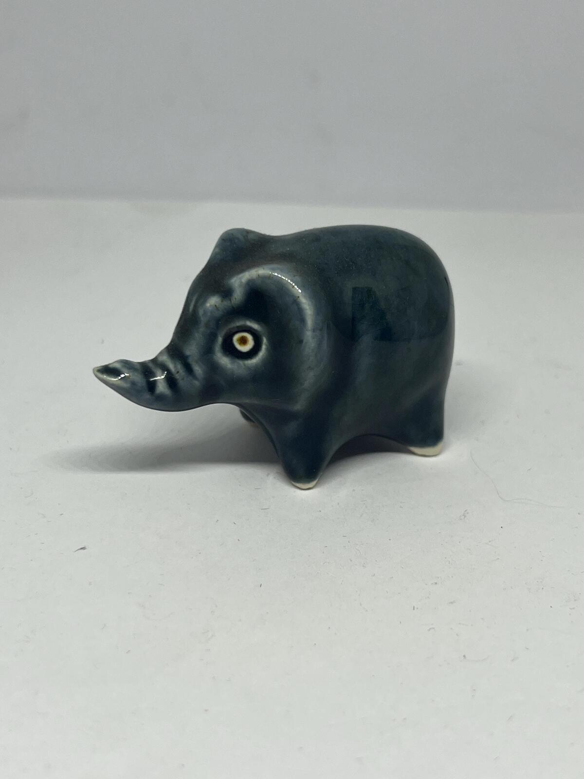 Tiny elephant figurine. Wellow pottery Blue green glaze stylised baby elephant.