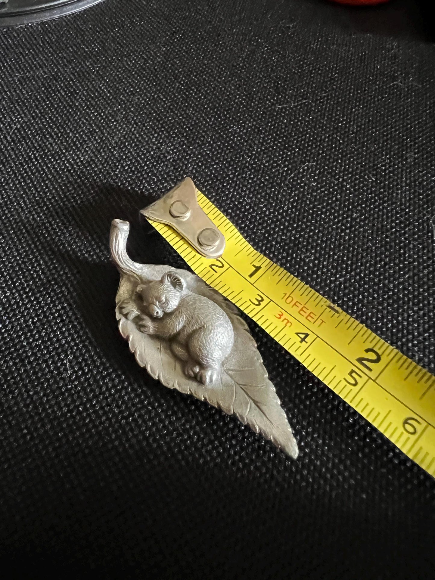 Tiny koala sleeping on a leaf. Pewter miniature figurine.