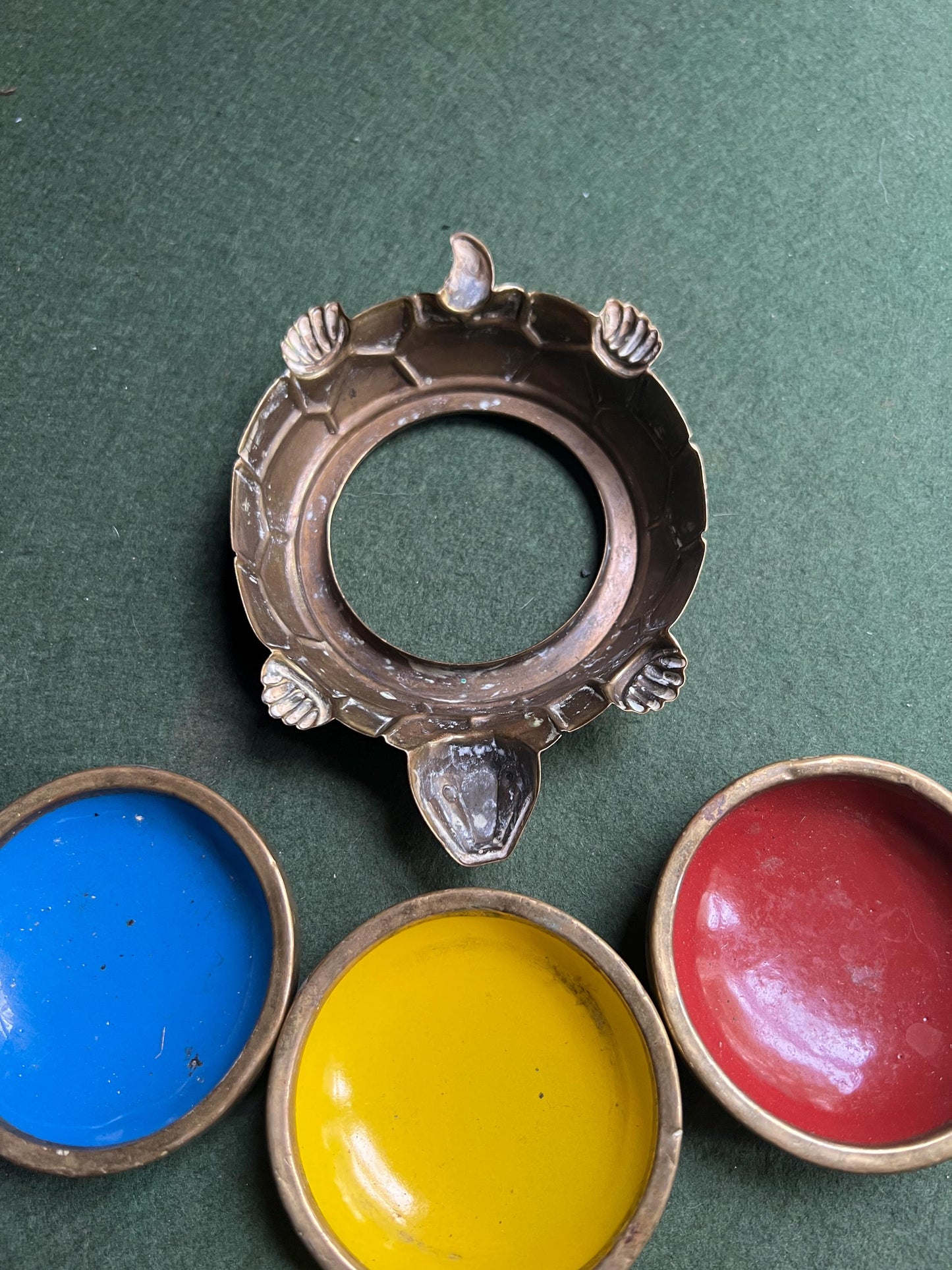 Quirky enamel brass stacking ashtrays on tortoise base.