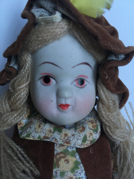 1970s ceramic doll in original clothes.