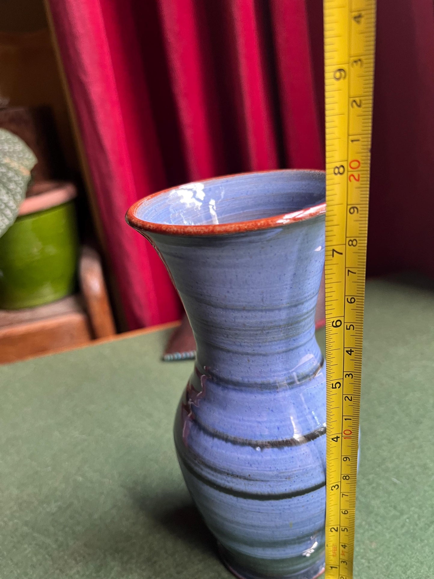Beautiful vintage studio pottery vase. Blue glaze with black swirl and red rim. Stamped WOLD