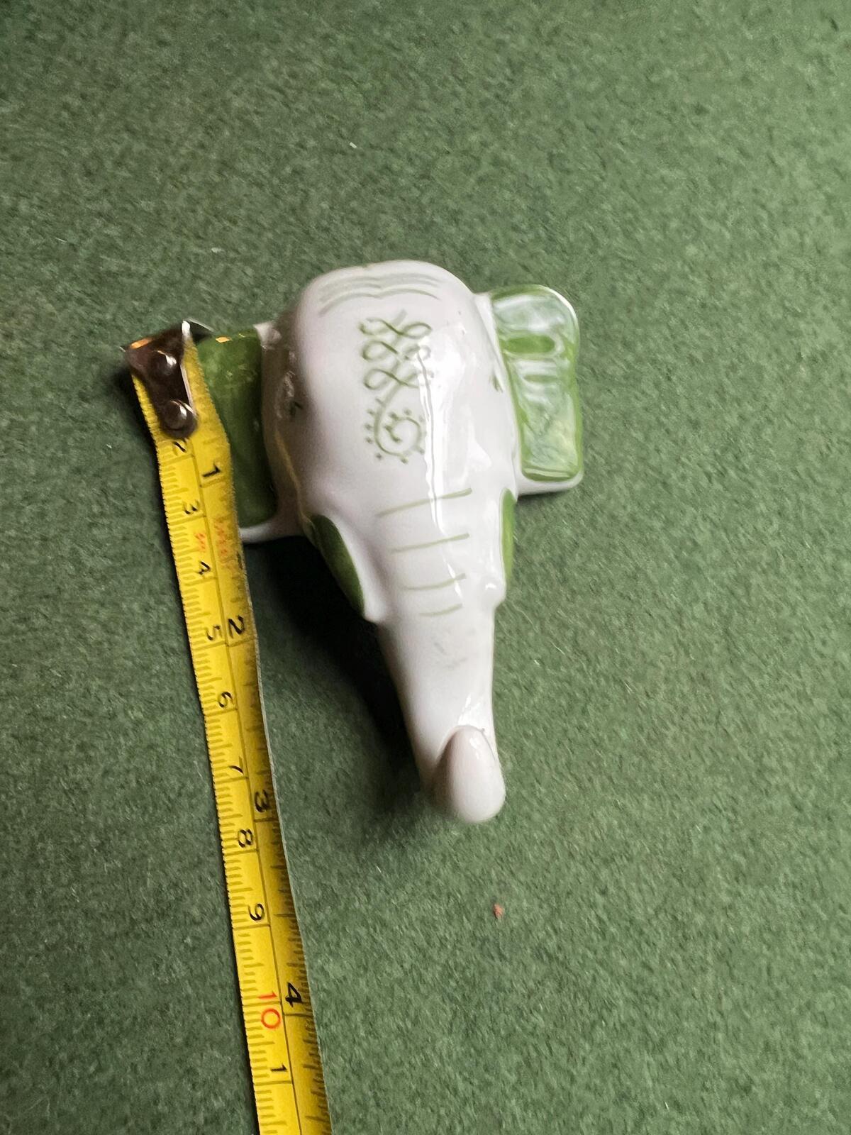 Vintage ceramic elephant head wall hanging. Hand painted green details.