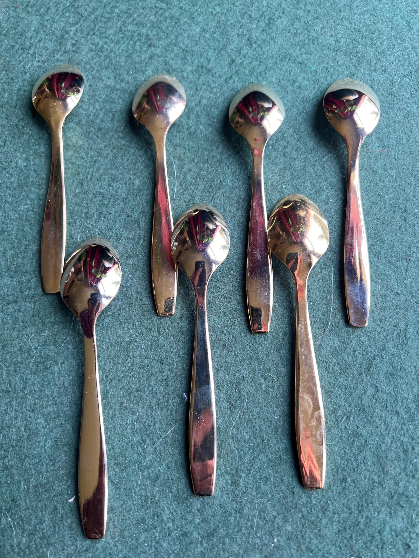 Set of seven Bronze plated sugar spoons with quirky handle end pattern.