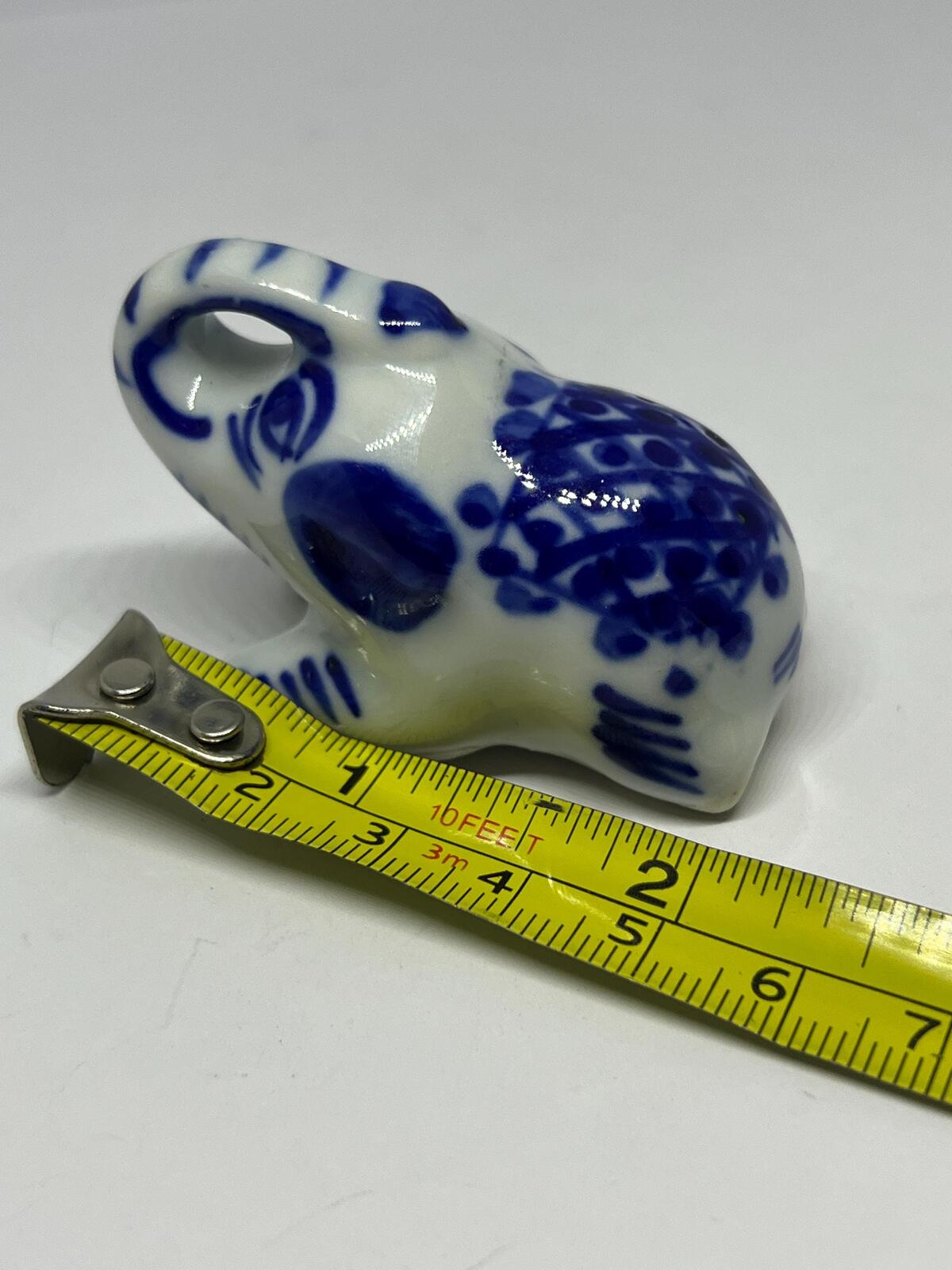 Lucky trunk up sitting elephant ornament. Blue white vintage elephant.
