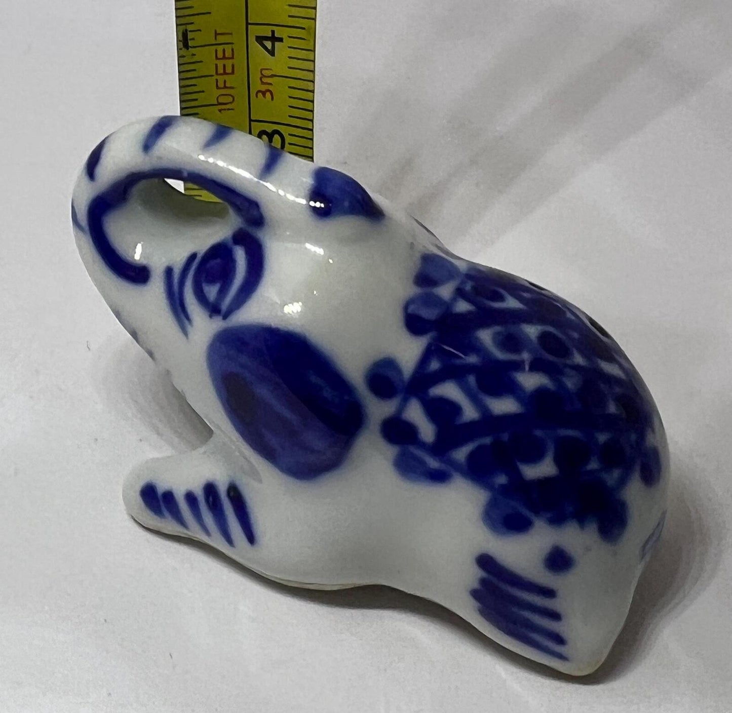 Lucky trunk up sitting elephant ornament. Blue white vintage elephant.