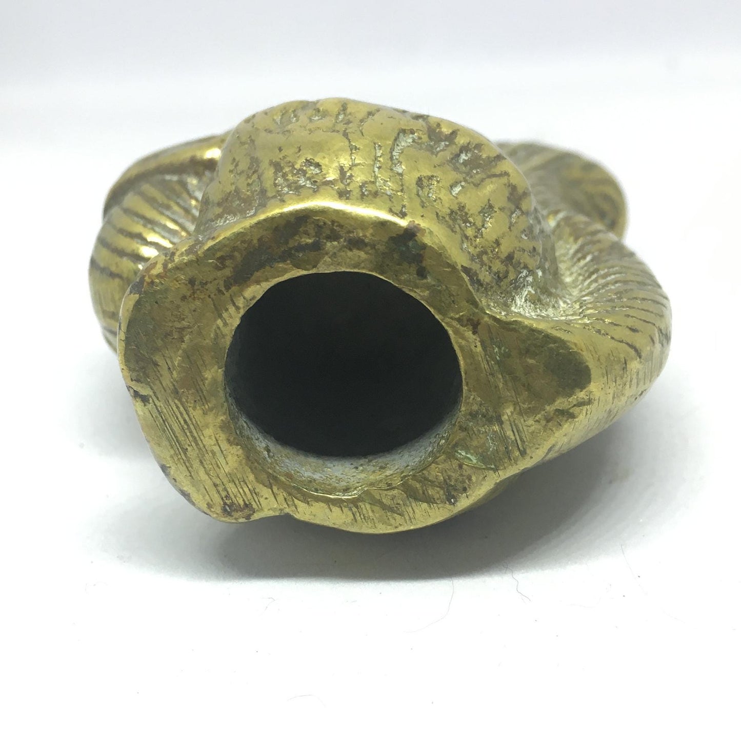 Vintage solid brass squirrel holding a nut.