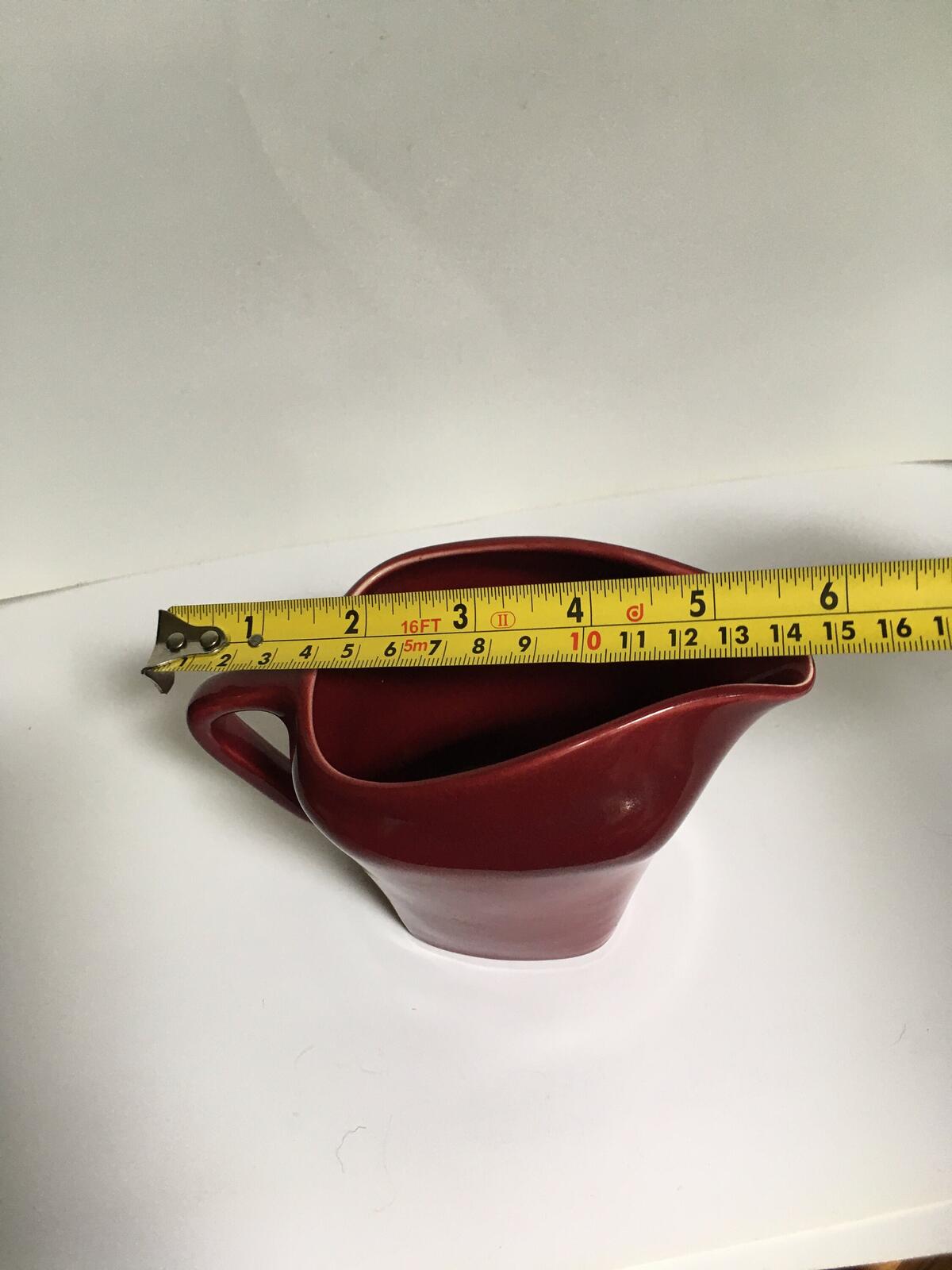 Deep red glazed gravy custard serving jug. Stamped South Seas JG Meakin.