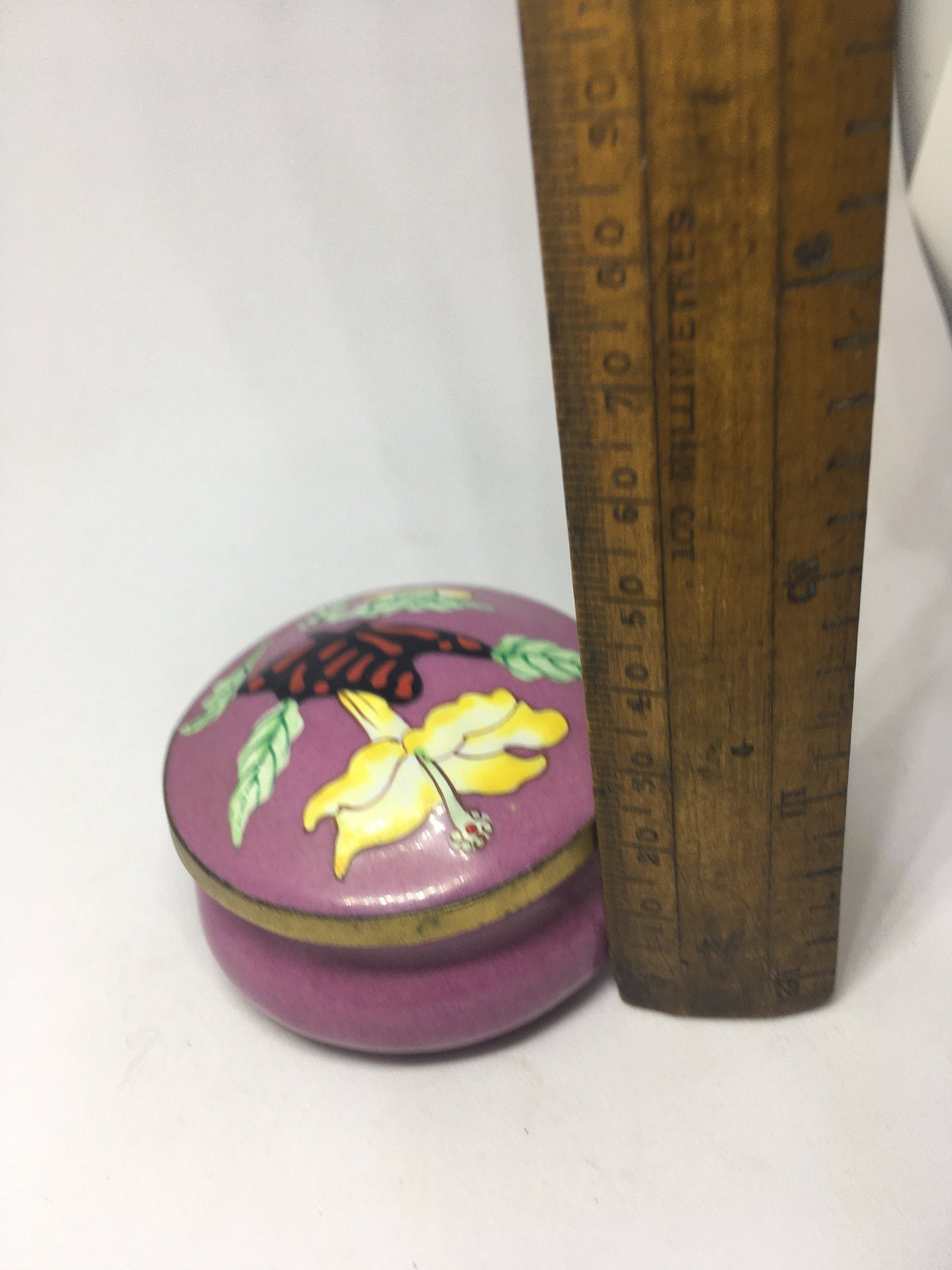 Enamel cloisonne lidded trinket box. Purple enamel with butterfly and flower decoration.