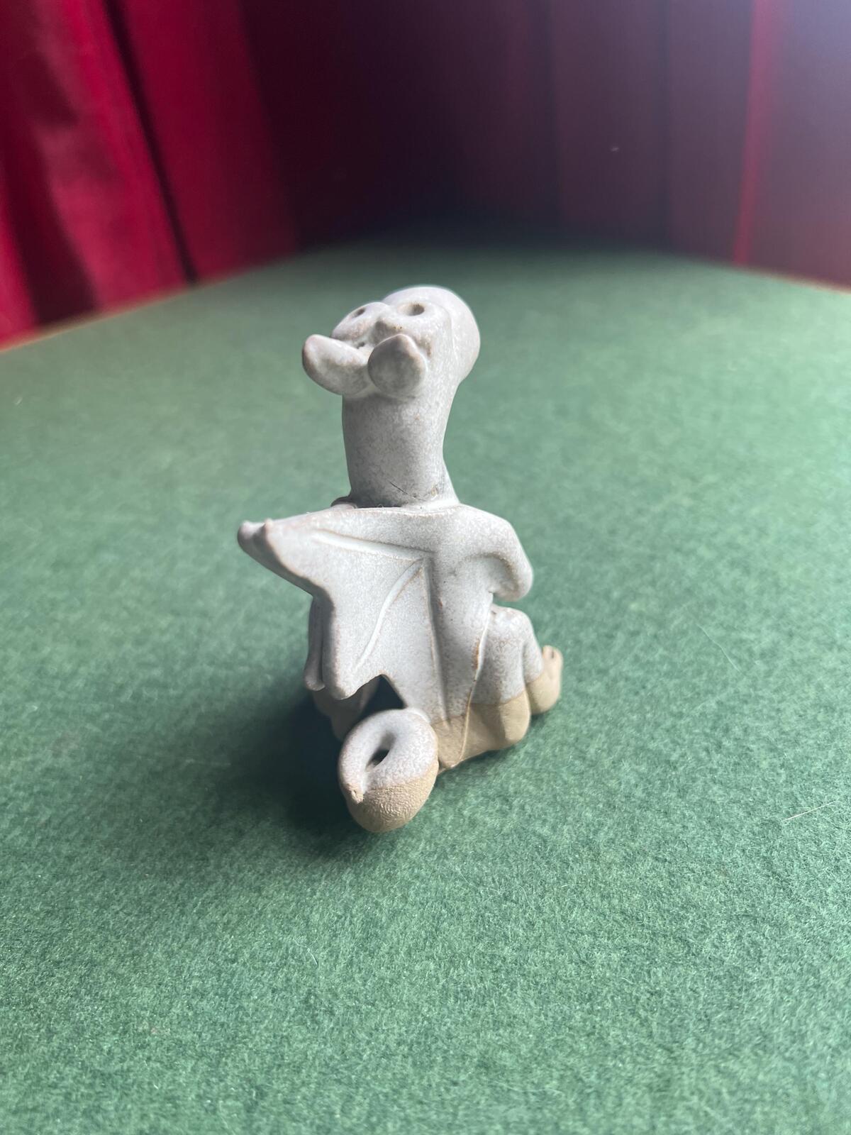 Hand built pottery dragon figurine. Grey clay ready to be painted dragon.
