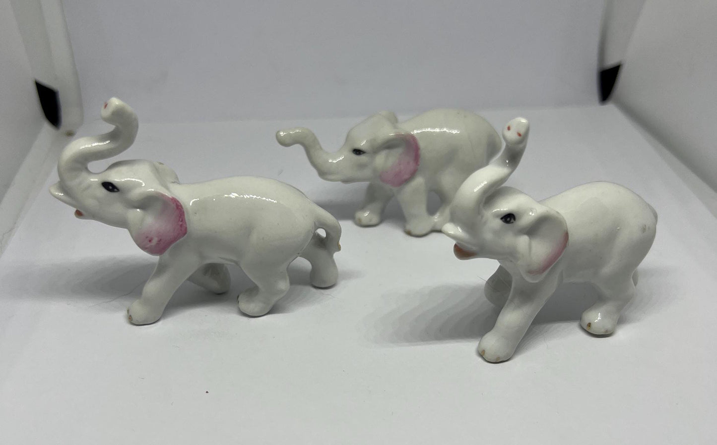 Ceramic elephant family. Lucky trunks raised mum dad and baby elephant collection.