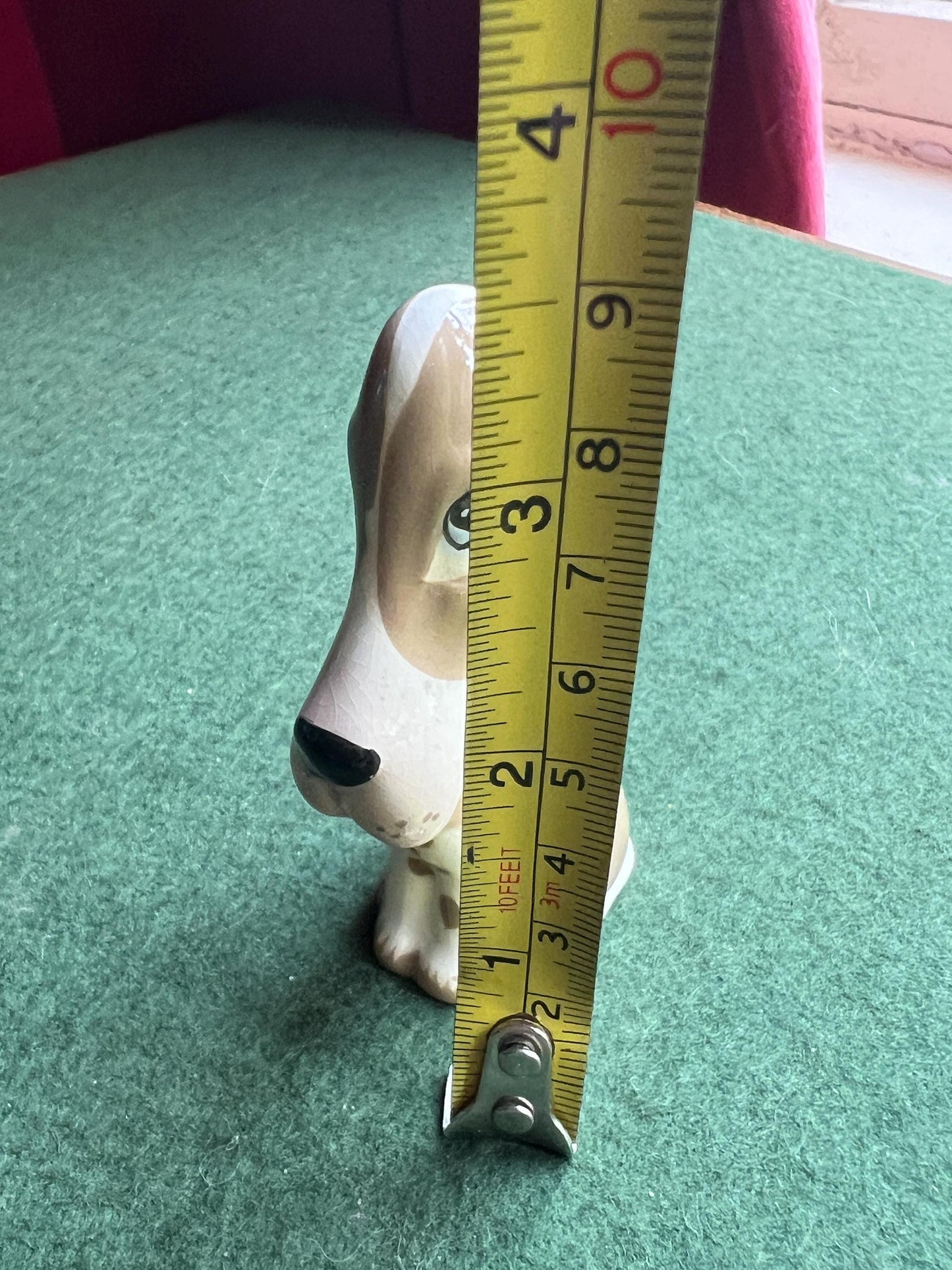 Ceramic sad hound dog figurine. Stamped Szeiler.