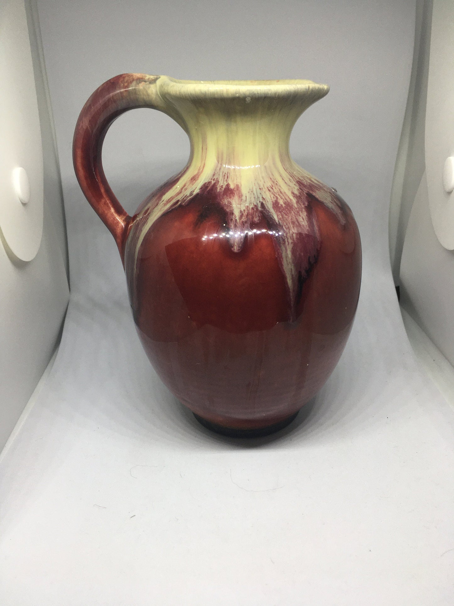 Water jug. German pottery pitcher. Beautiful red and cream drip glazed. Marked Germany.