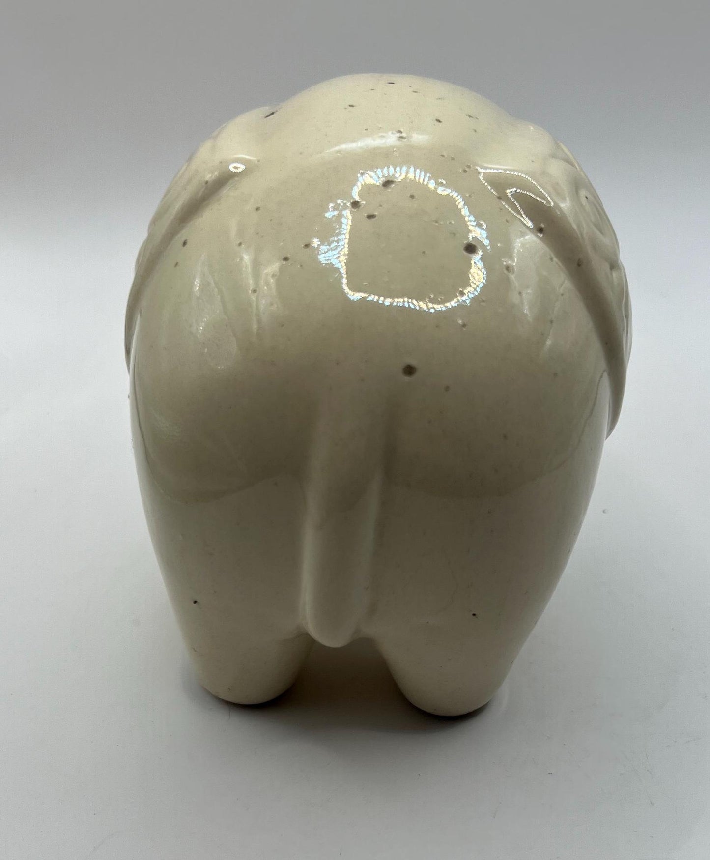 Quirky ceramic elephant figurine with decorated ears.