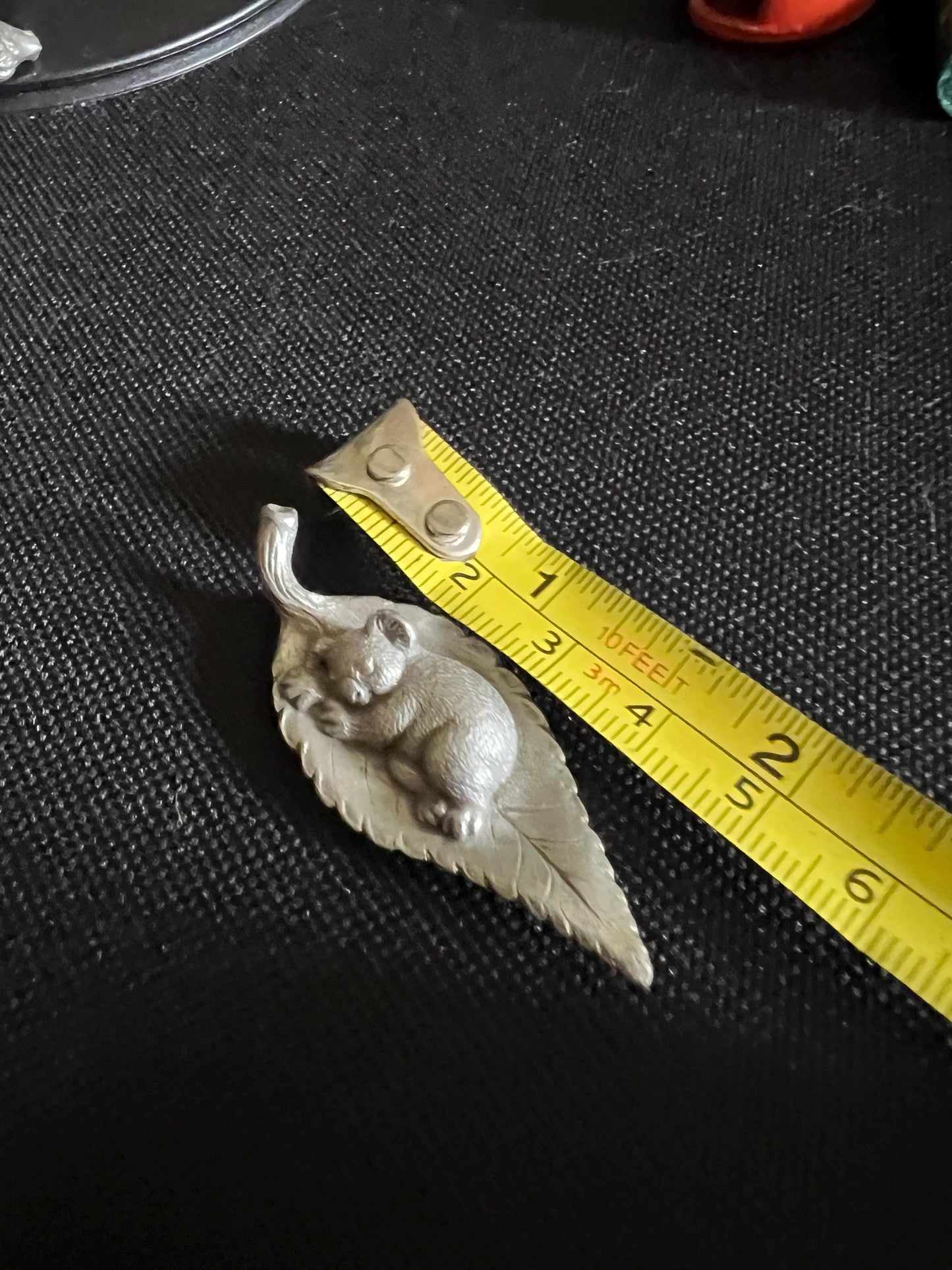 Tiny koala sleeping on a leaf. Pewter miniature figurine.