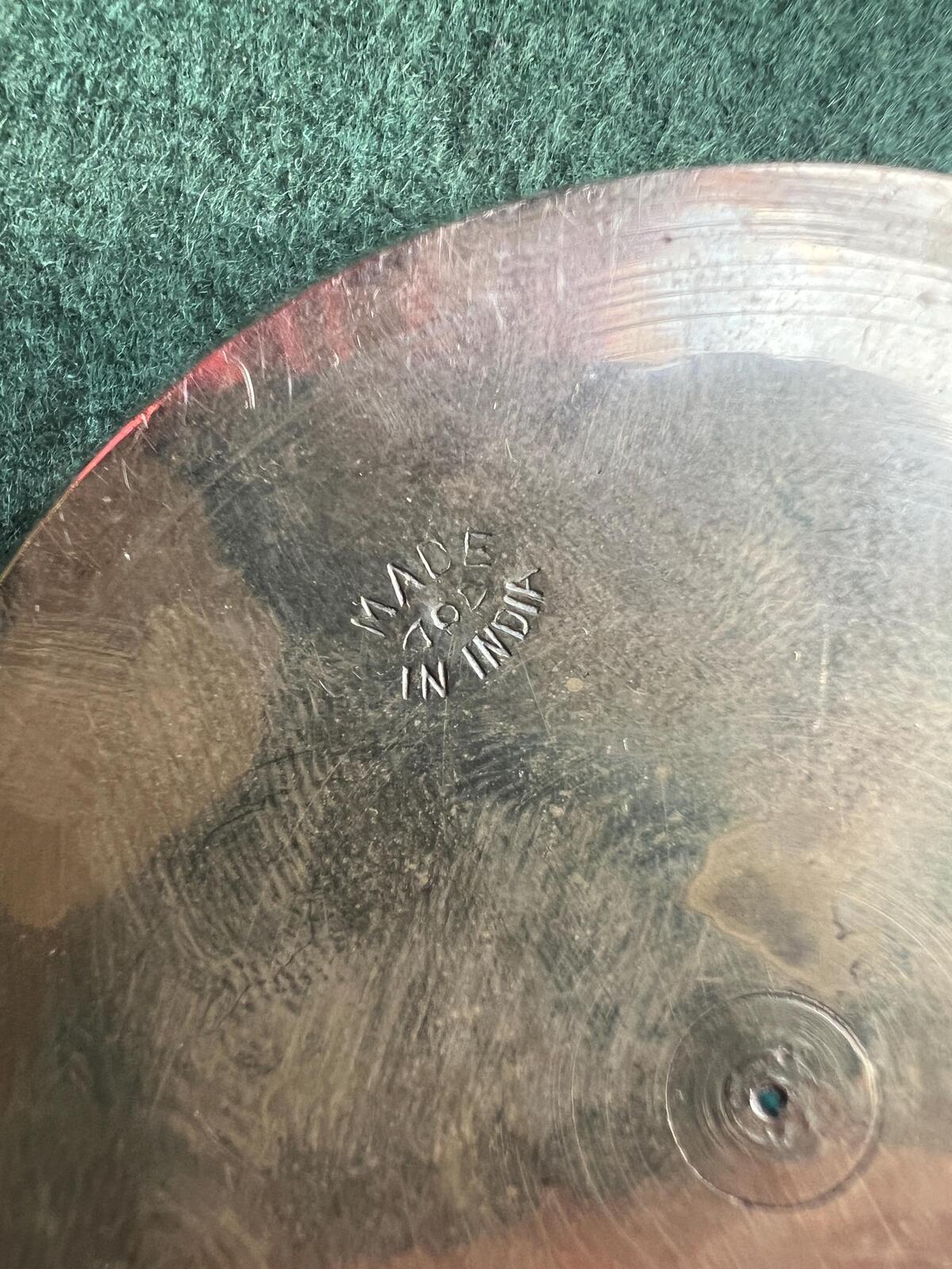 Decorative brass trinket tray. Engraved intricate red pattern. Made in India.