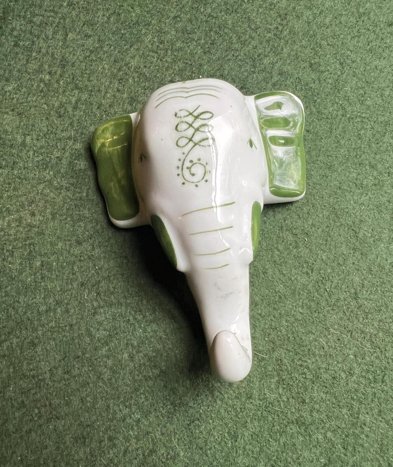 Vintage ceramic elephant head wall hanging. Hand painted green details.