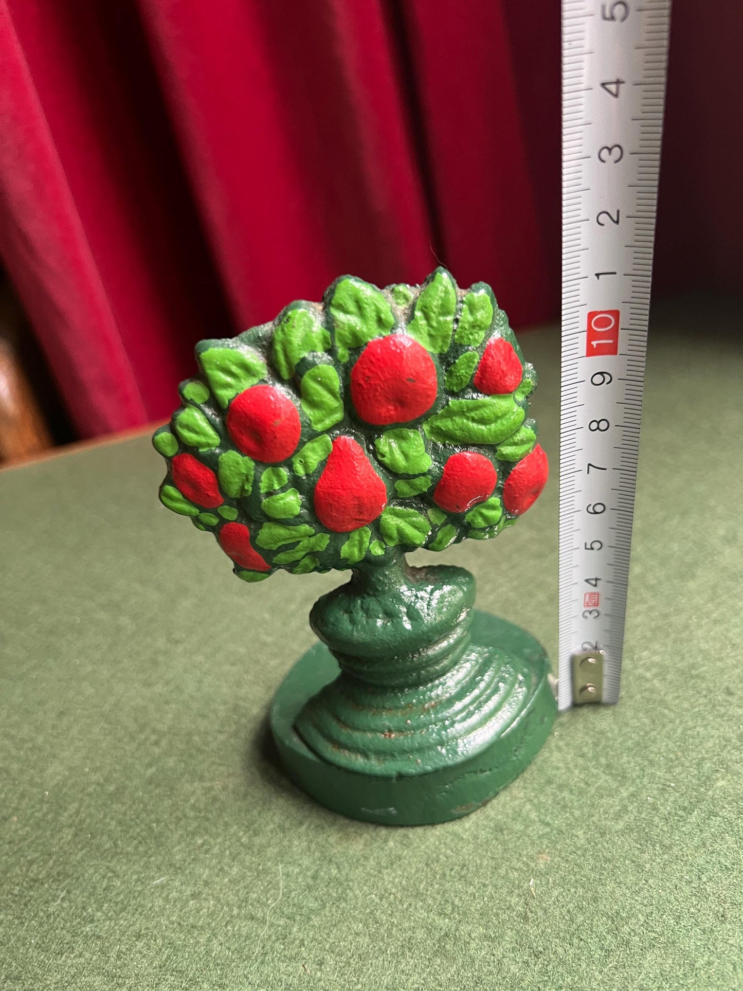 Vintage cast iron door stop. Hand painted red green Apple tree door wedge.