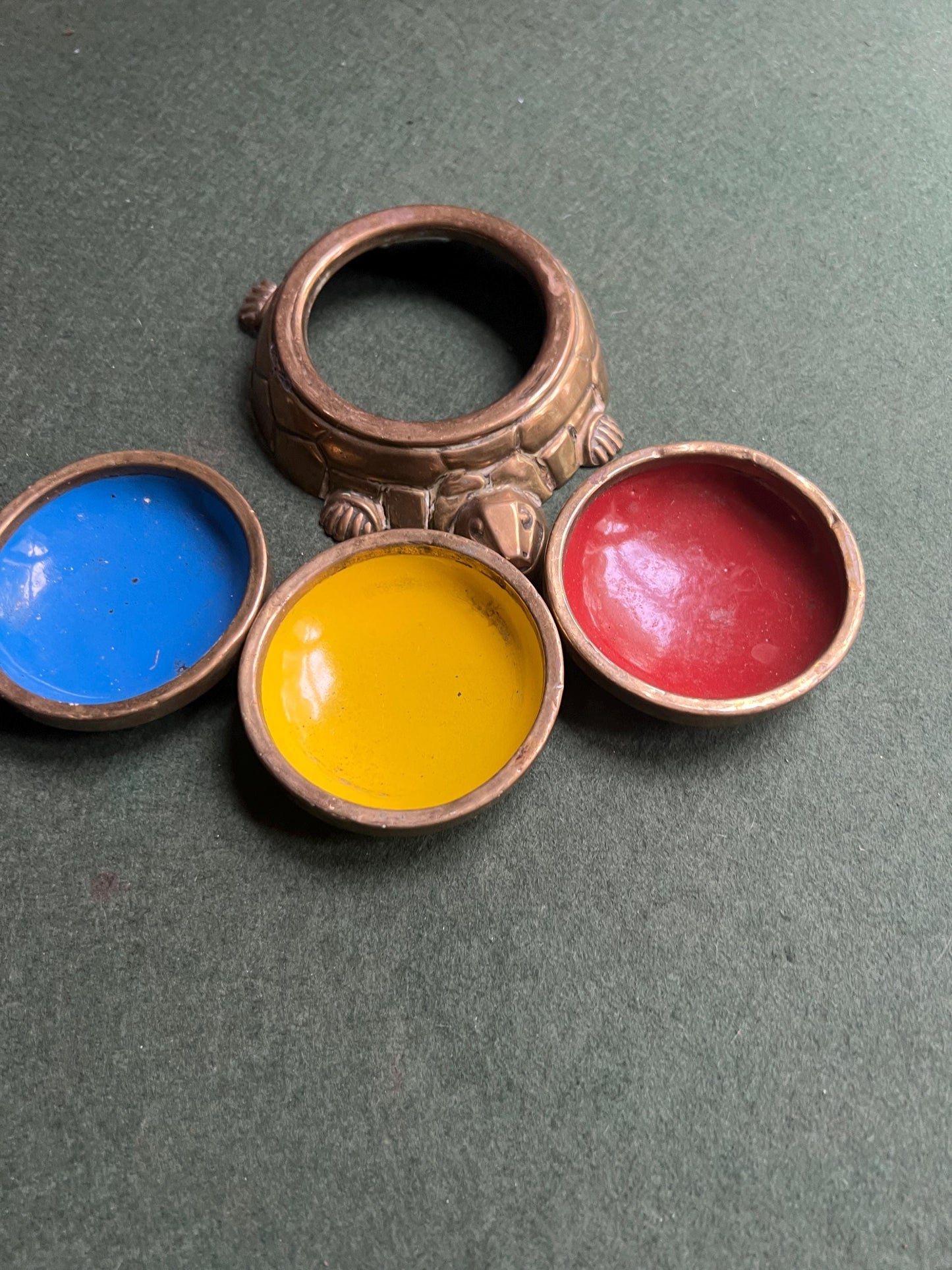 Quirky enamel brass stacking ashtrays on tortoise base.