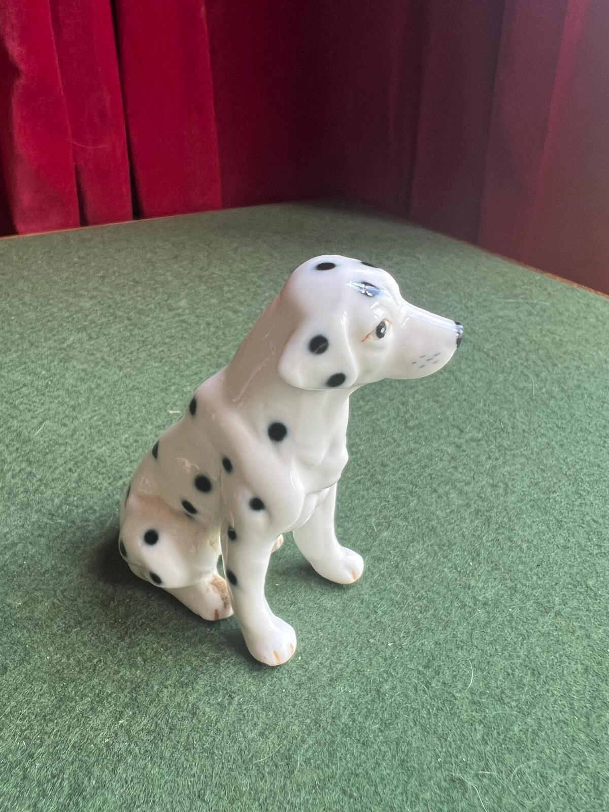 Vintage ceramic dalmatian dog figurine. Porcelain black and white spotty dog.