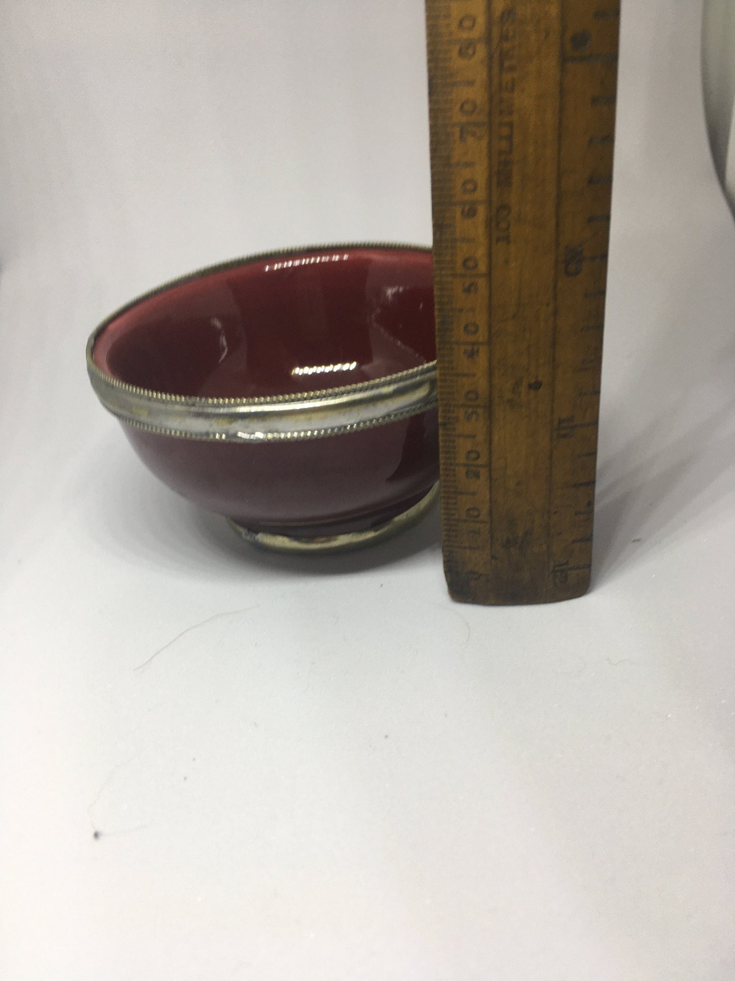 Vintage red glazed trinket pin dish with silver tone band.