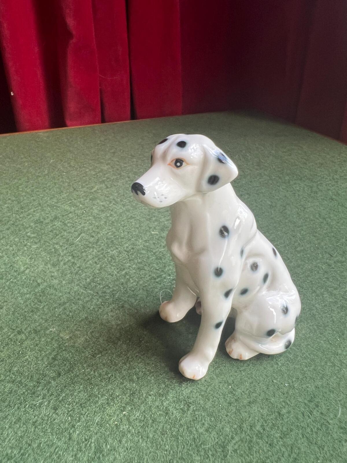 Vintage ceramic dalmatian dog figurine. Porcelain black and white spotty dog.