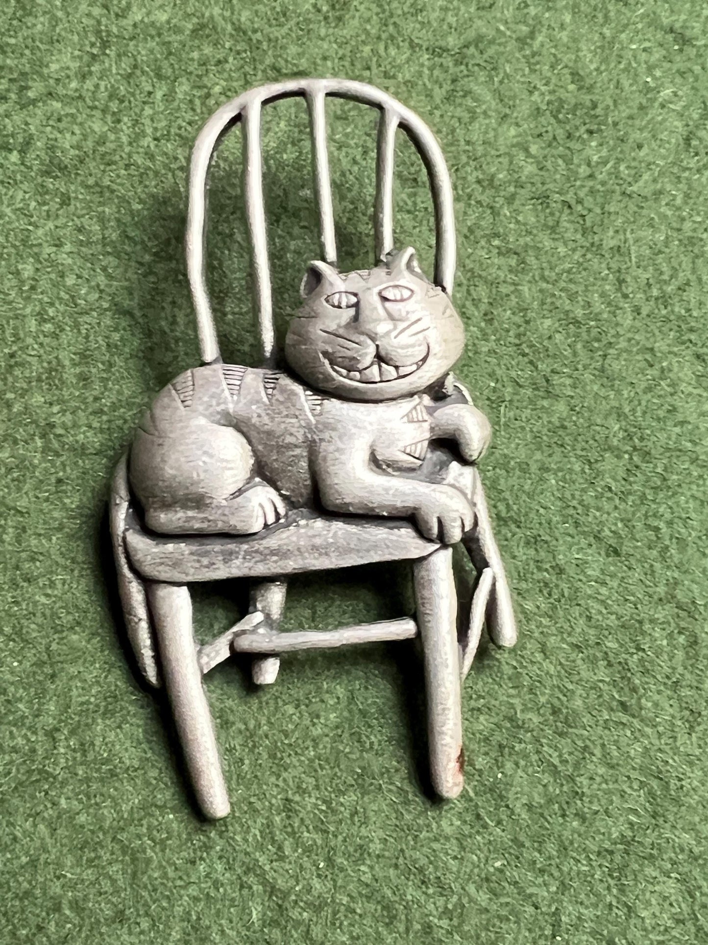 Vintage Cat brooch Signed JJ. Grinning Cheshire Cat sitting on a chair.
