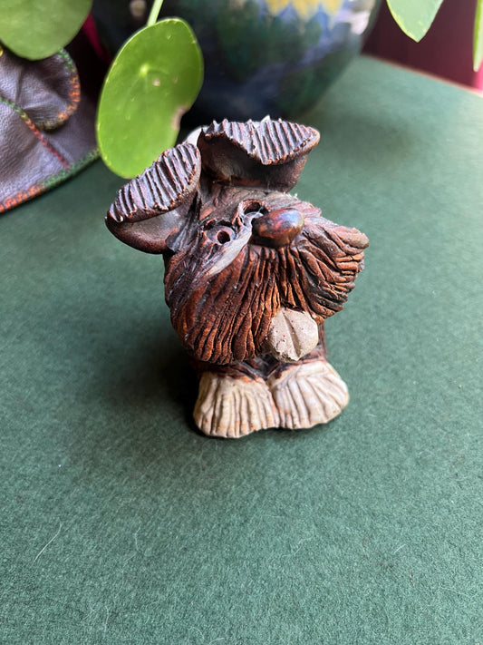 Hand built studio pottery brown glazed dog with its tongue out and quirky ears.