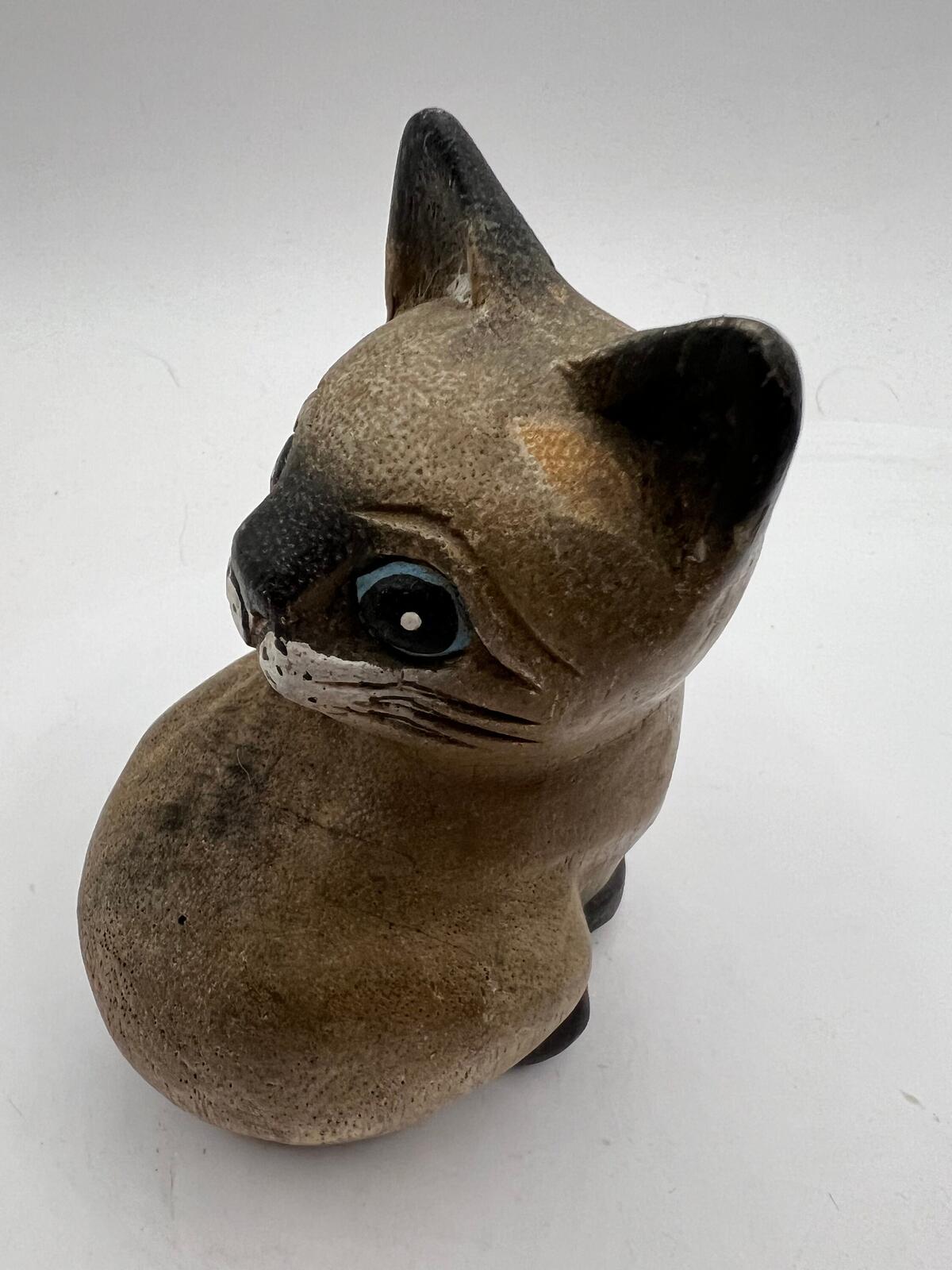 Vintage hand carved wooden quirky cat kitten figurine looking over its shoulder.