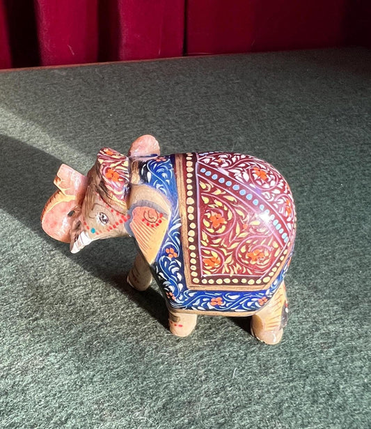 Decorative hand carved soapstone elephant in ceremonial dress.