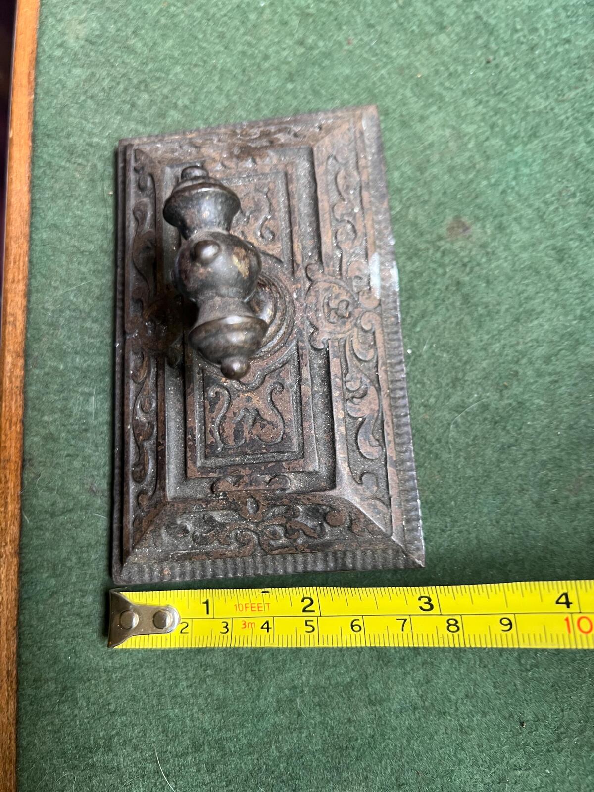 Ornate antique cast iron paperweight. Handled Victorian paperweight doorstop. Decorative pyramid swirl patterned quirky paperweight.
