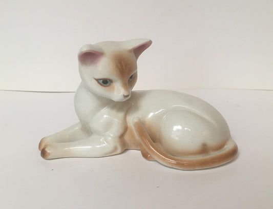 Relaxing cat figurine. Beautiful vintage hand painted ceramic blue-eyed cat.
