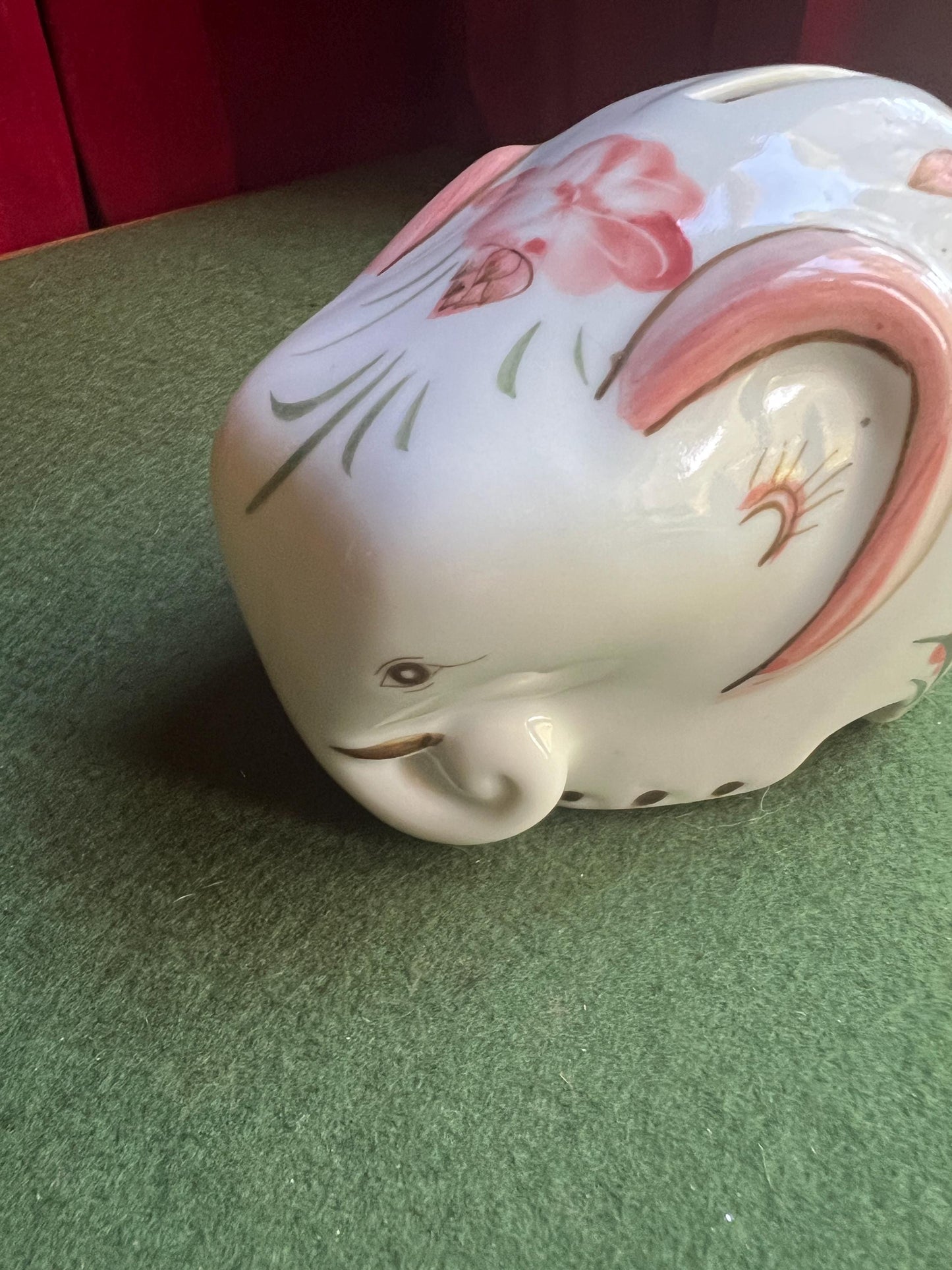 Ceramic elephant money box. Hand painted pink floral design. Made in Thailand.