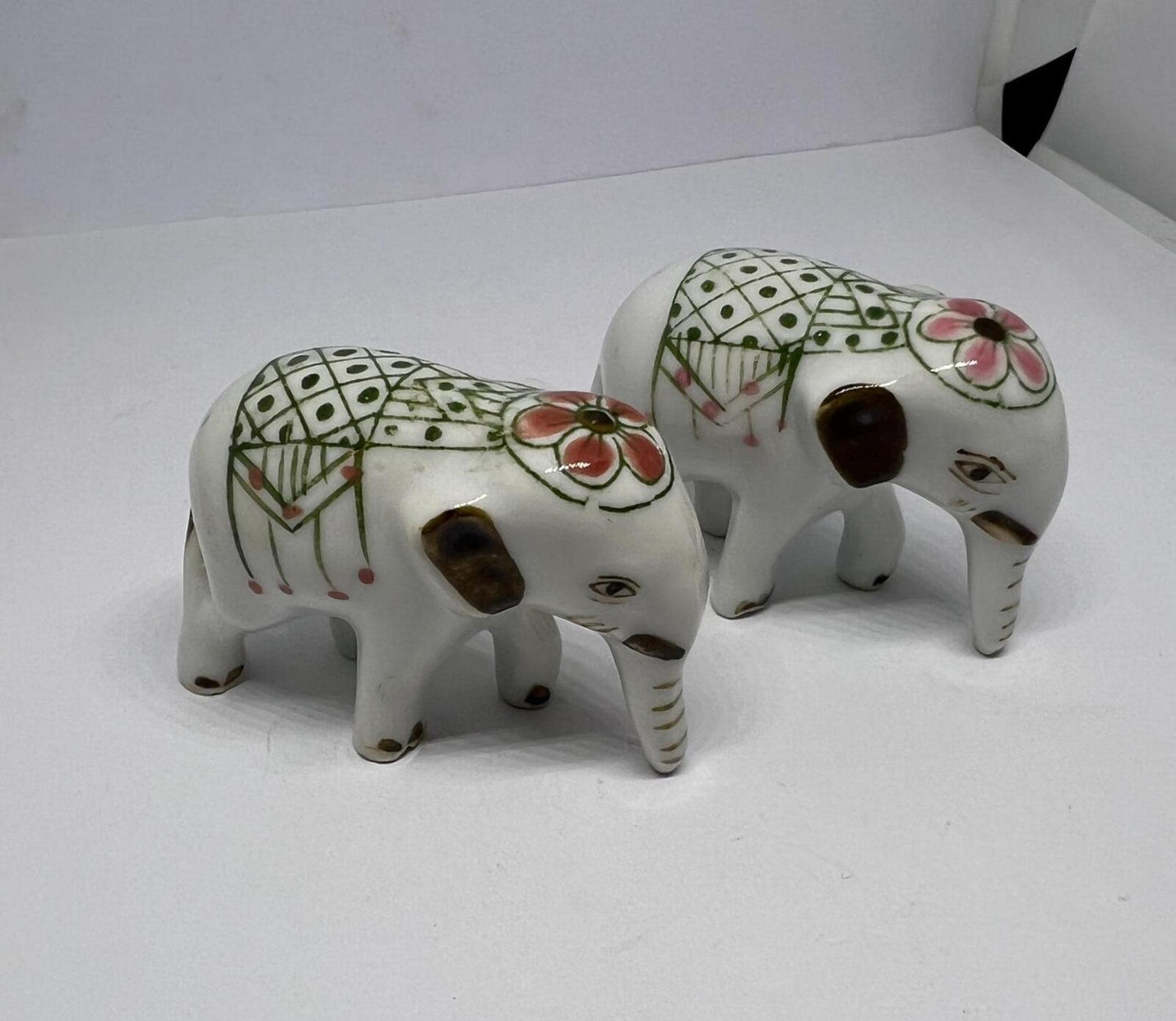 Tiny pair ceramic elephants. Mini ceremonial dress with floral headdress