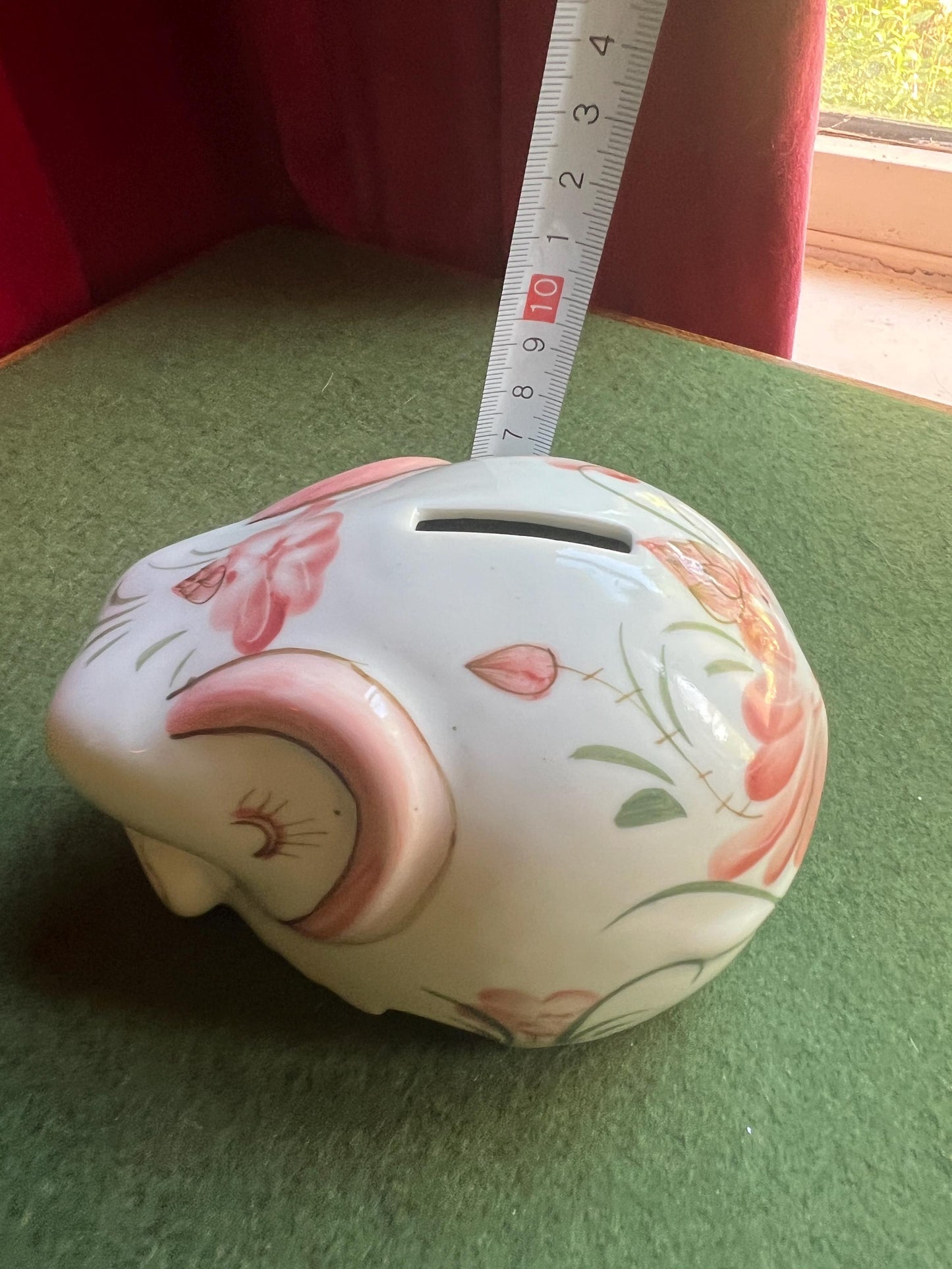 Ceramic elephant money box. Hand painted pink floral design. Made in Thailand.