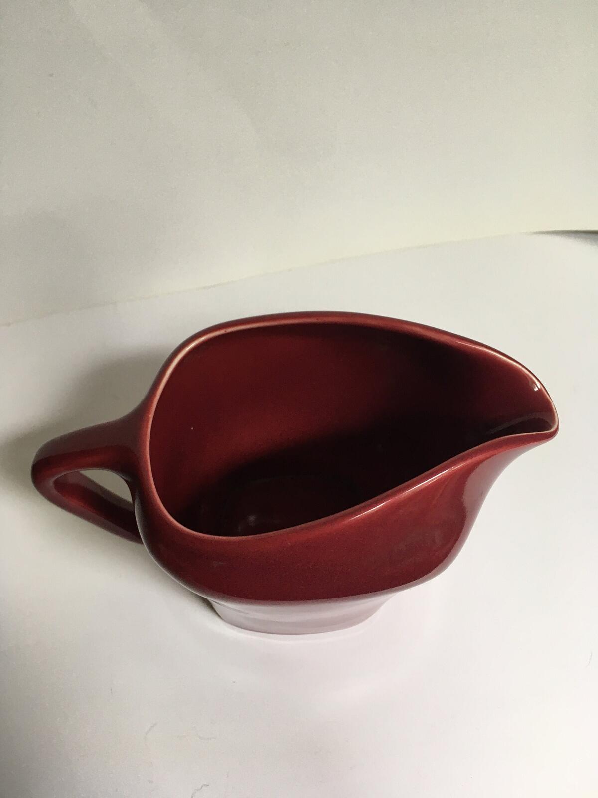 Deep red glazed gravy custard serving jug. Stamped South Seas JG Meakin.