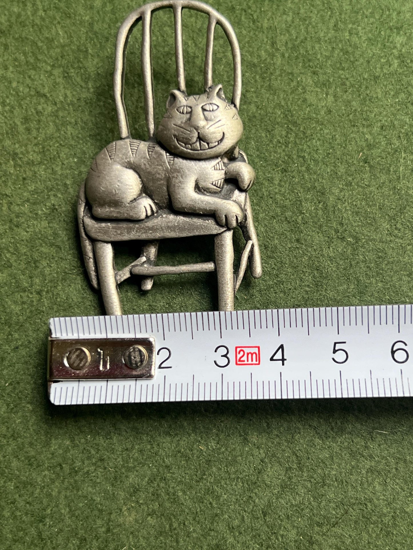 Vintage Cat brooch Signed JJ. Grinning Cheshire Cat sitting on a chair.