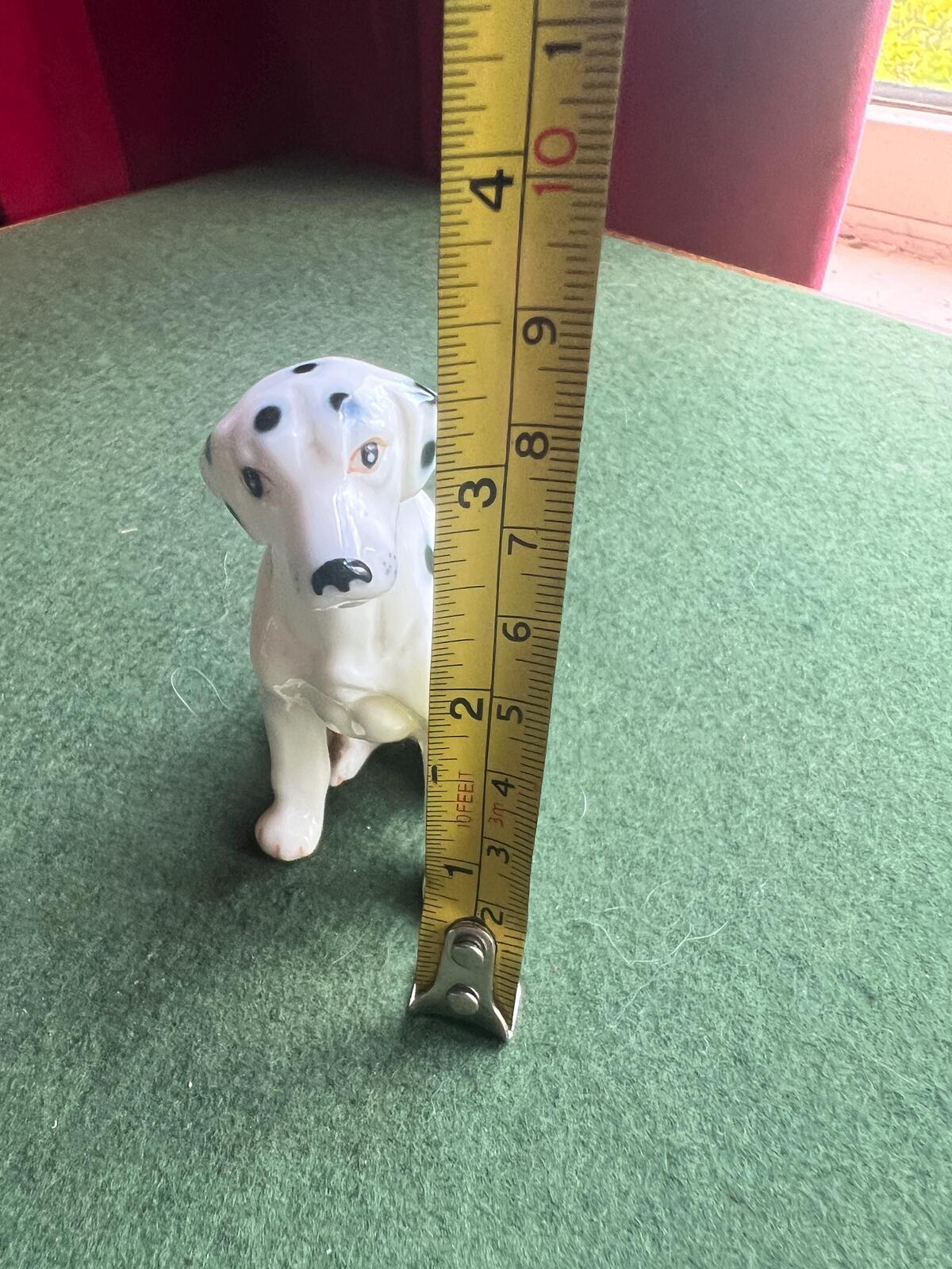 Vintage ceramic dalmatian dog figurine. Porcelain black and white spotty dog.