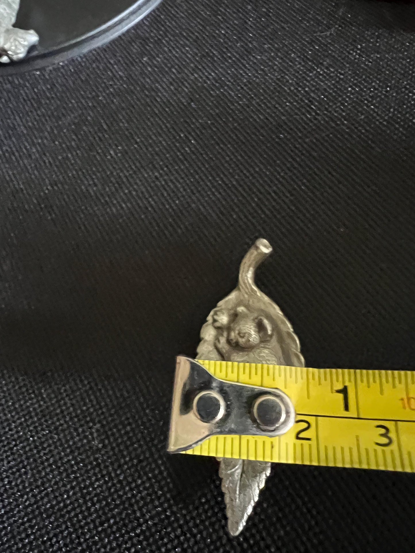 Tiny koala sleeping on a leaf. Pewter miniature figurine.