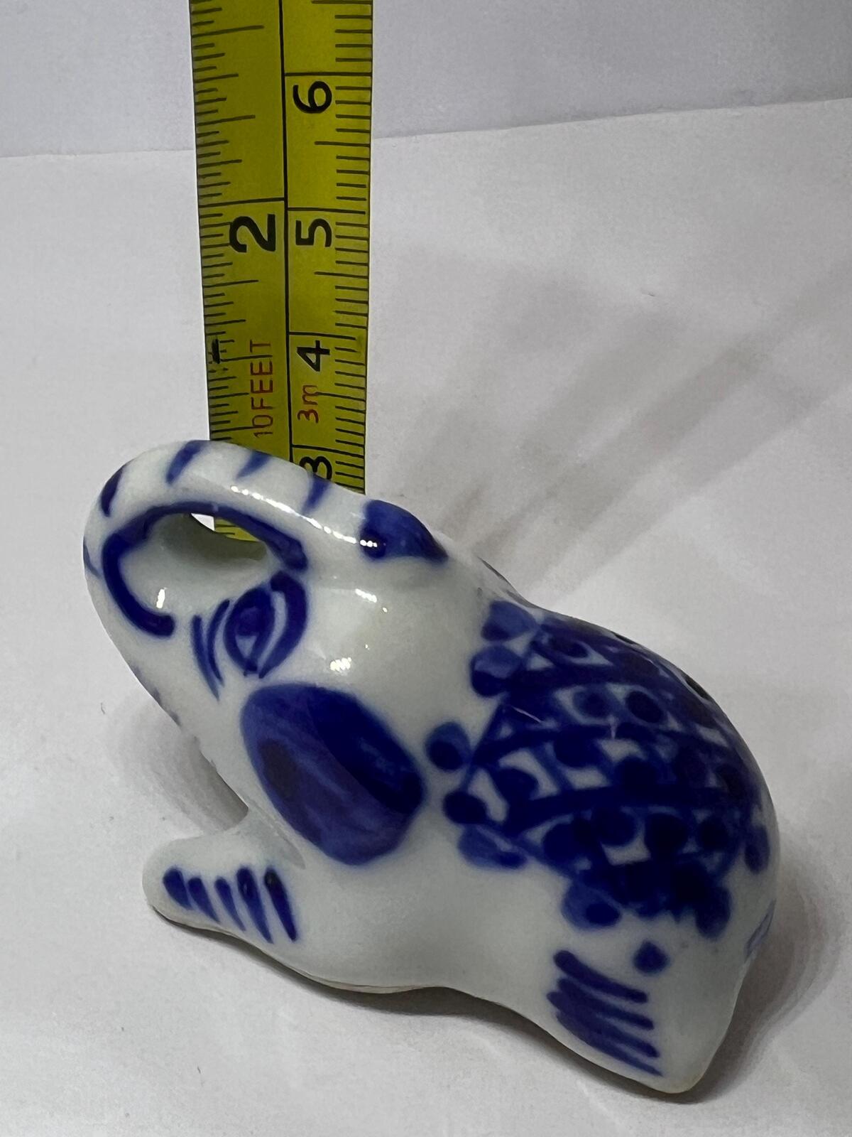 Lucky trunk up sitting elephant ornament. Blue white vintage elephant.