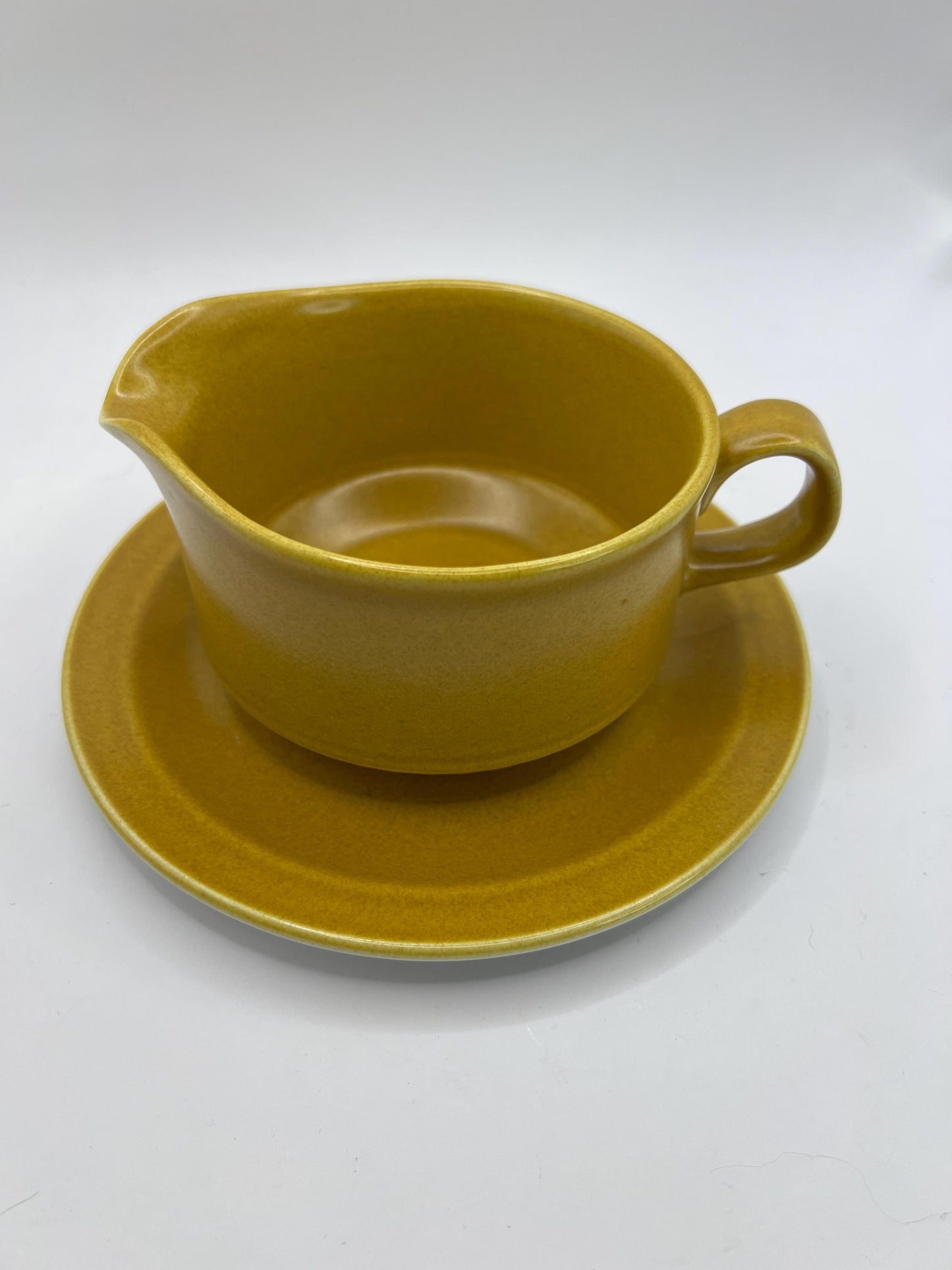 Mustard yellow ceramic gravy sauce boat and saucer. Stamped Glo-white Ironstone Alfred Meakin England.