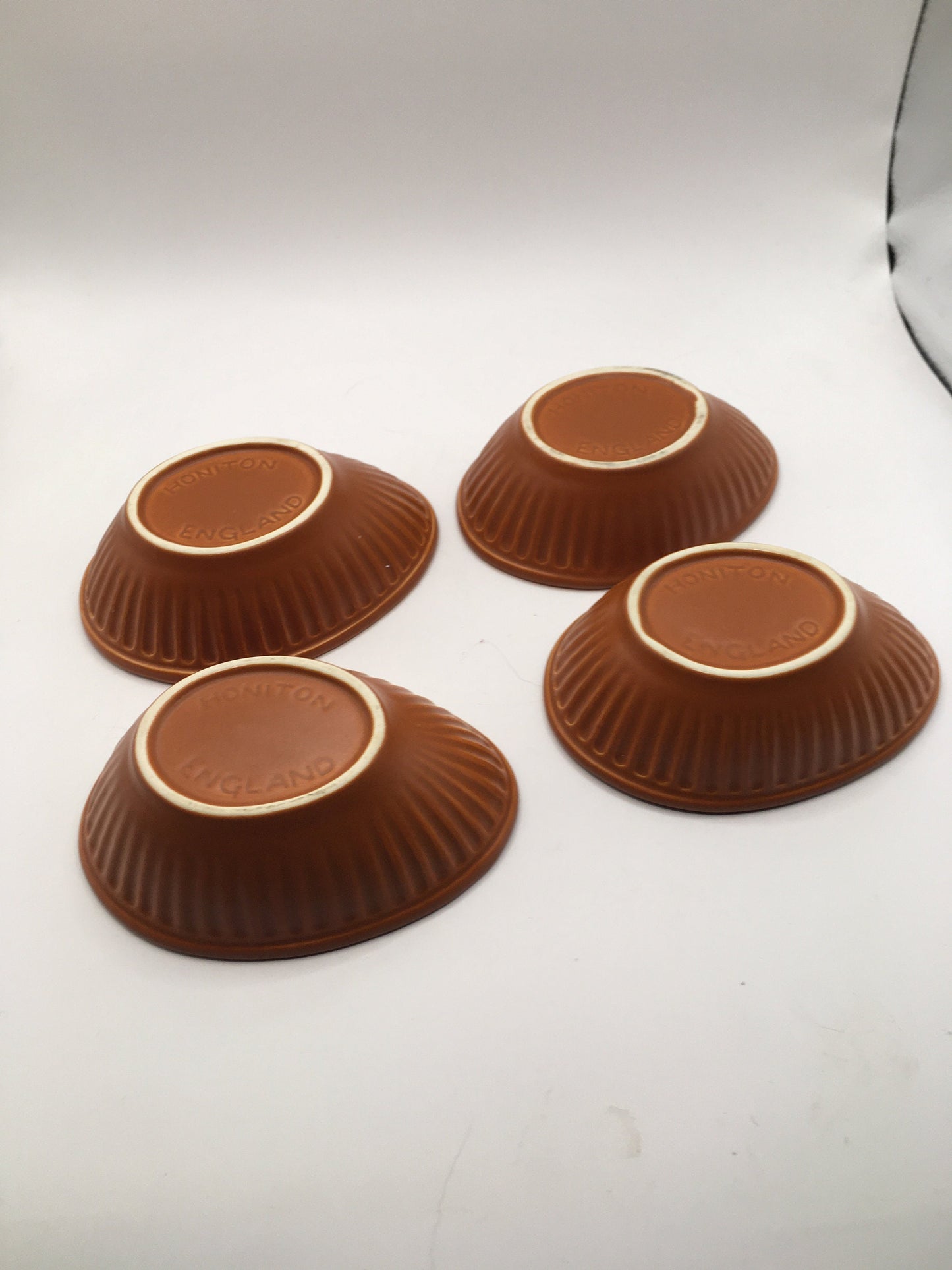 Honiton Pottery Avocado dishes. Set of 4 orange glazed stripe edged set.